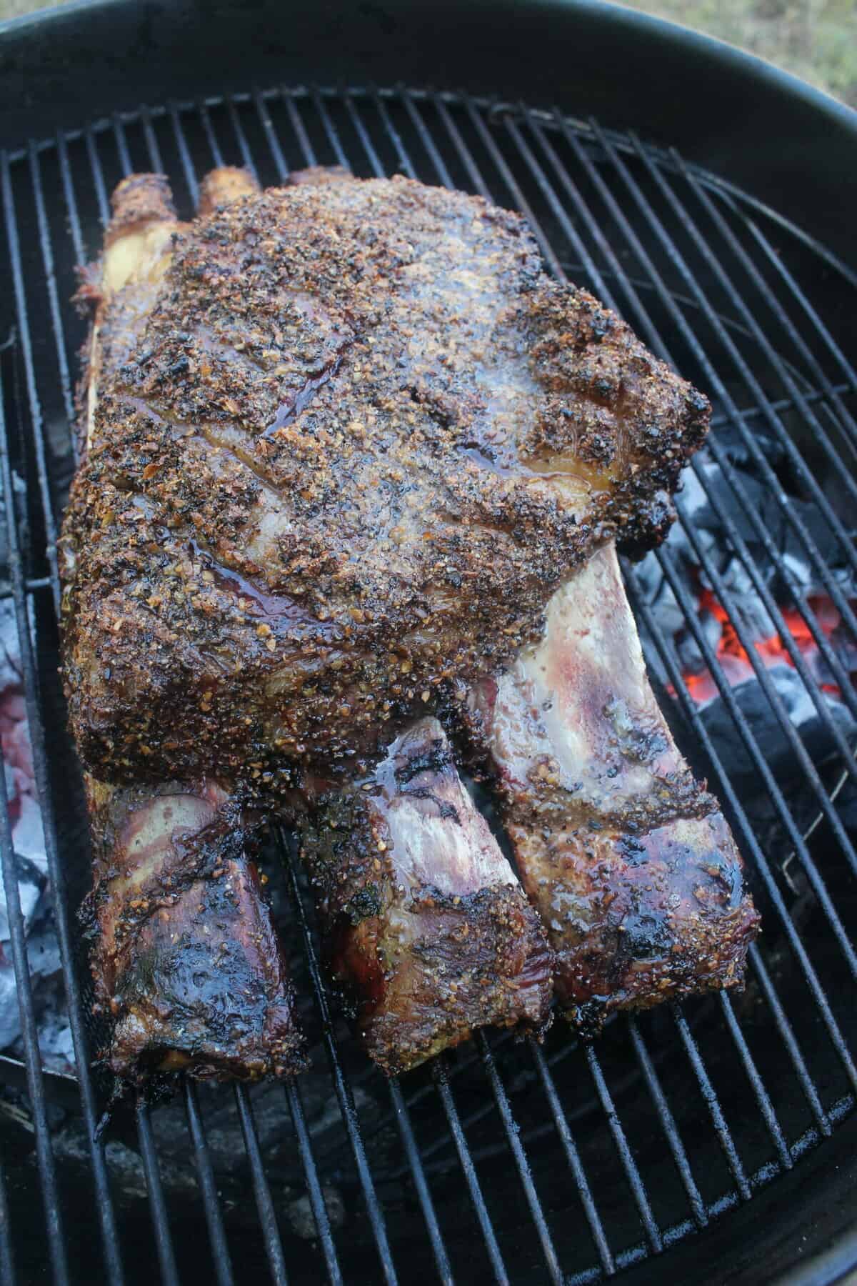 The beef ribs after they've cooked, still sitting on the grill. 