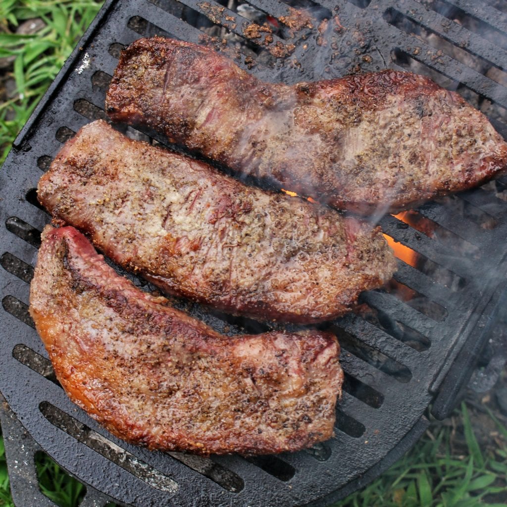 wagyu secreto steak cooking over fire