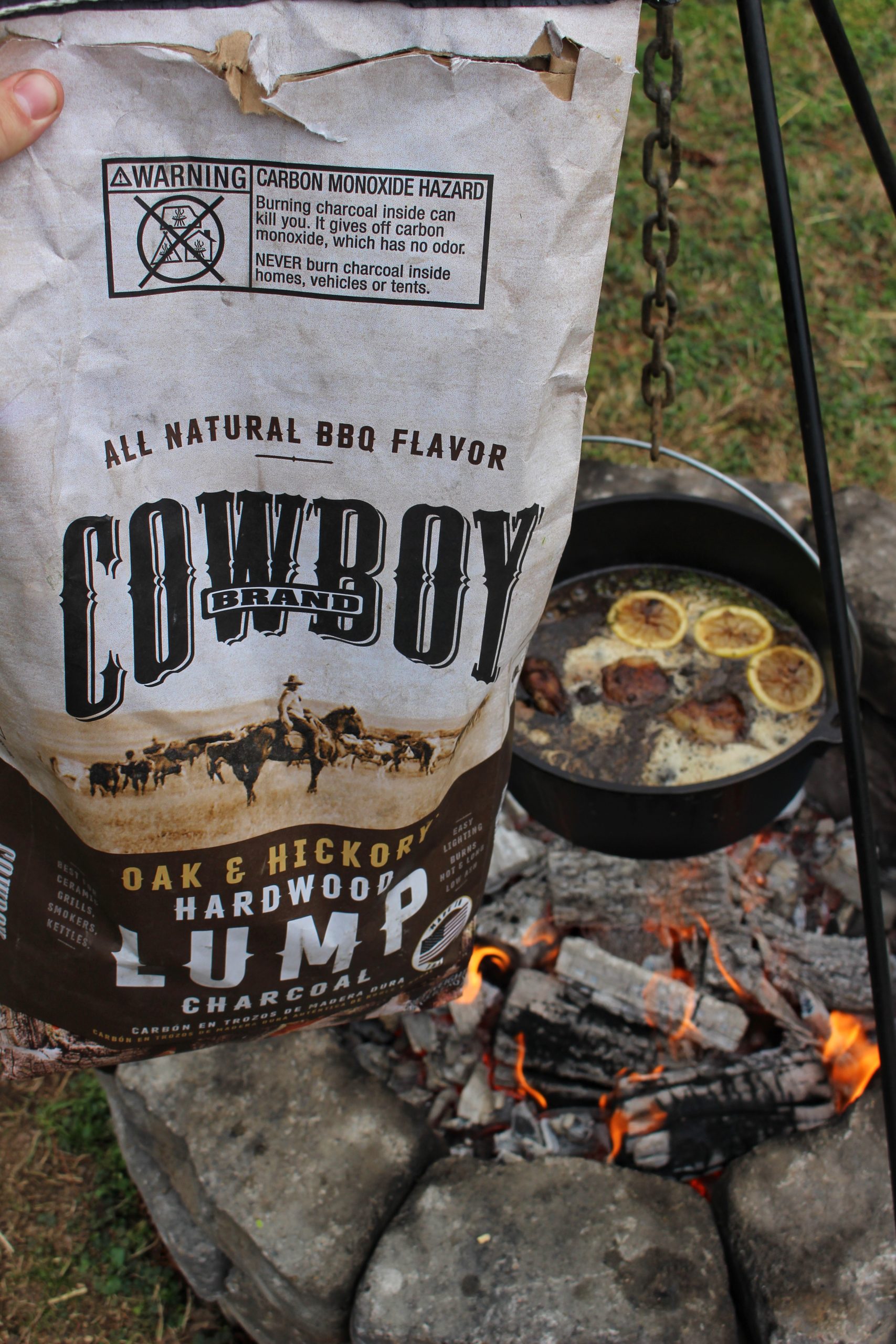 A close up shot of Cowboy Charcoal with the dish cooking in the background. 