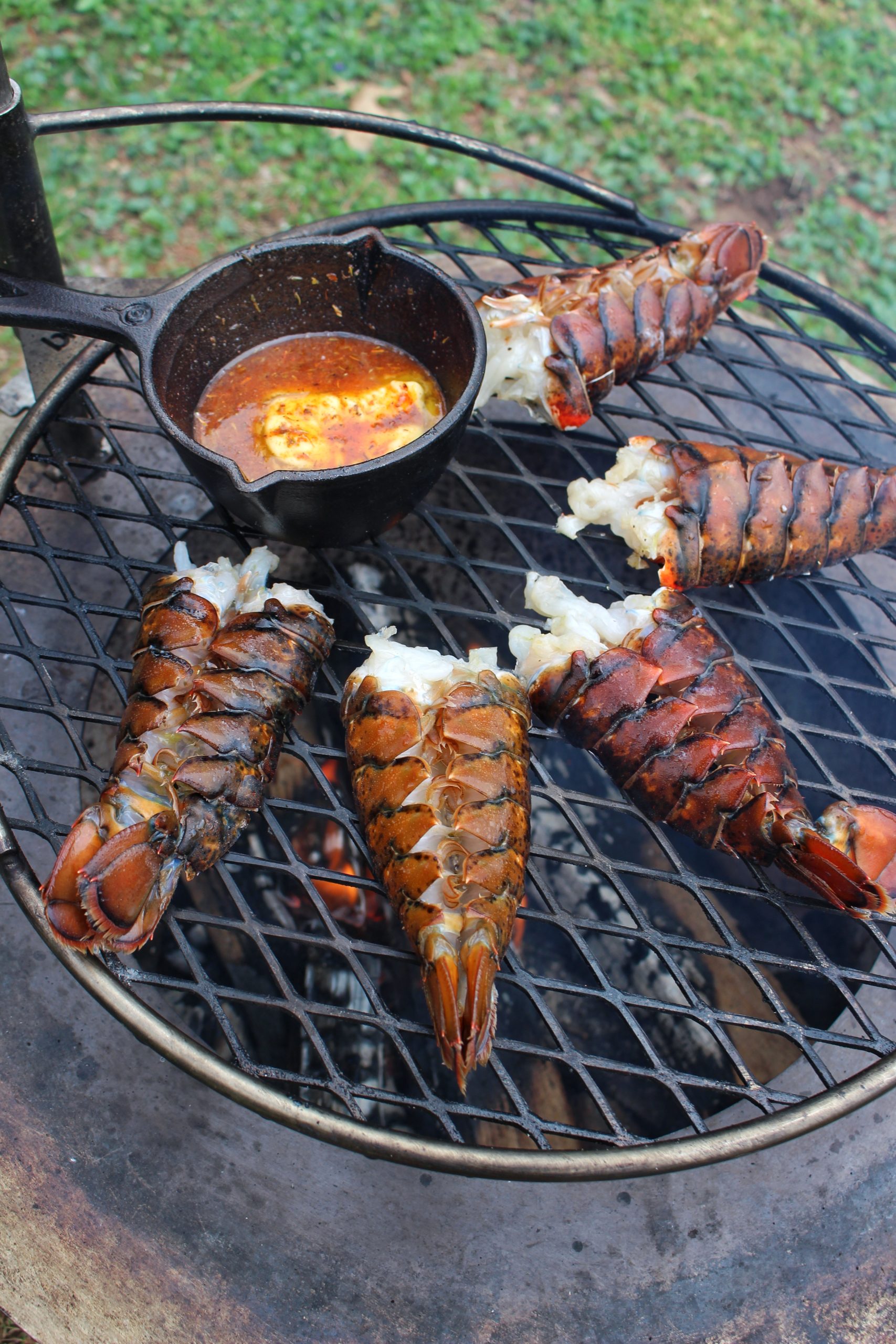 Grilled Lobster Tails with Honey Cajun Butter - Over The Fire Cooking