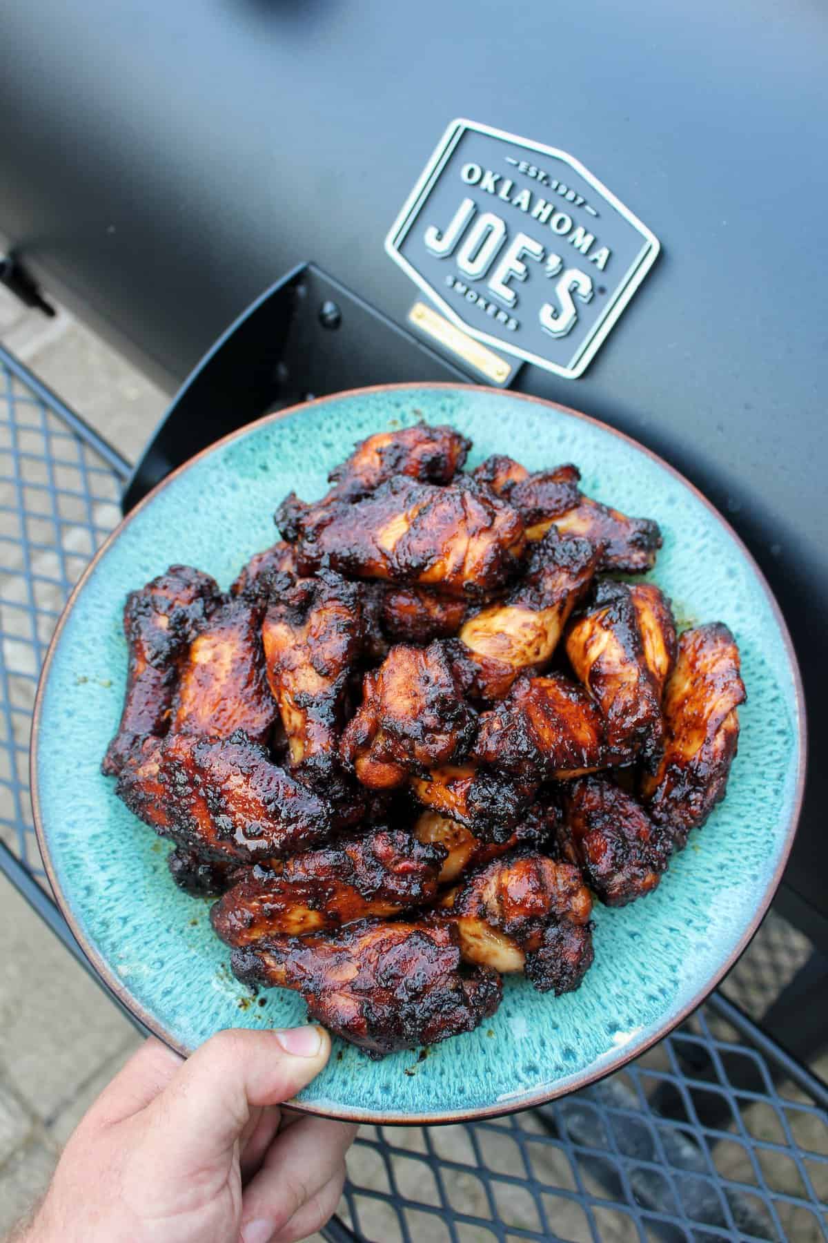 Smoked and Fried Sticky Wings sitting on a serving platter.