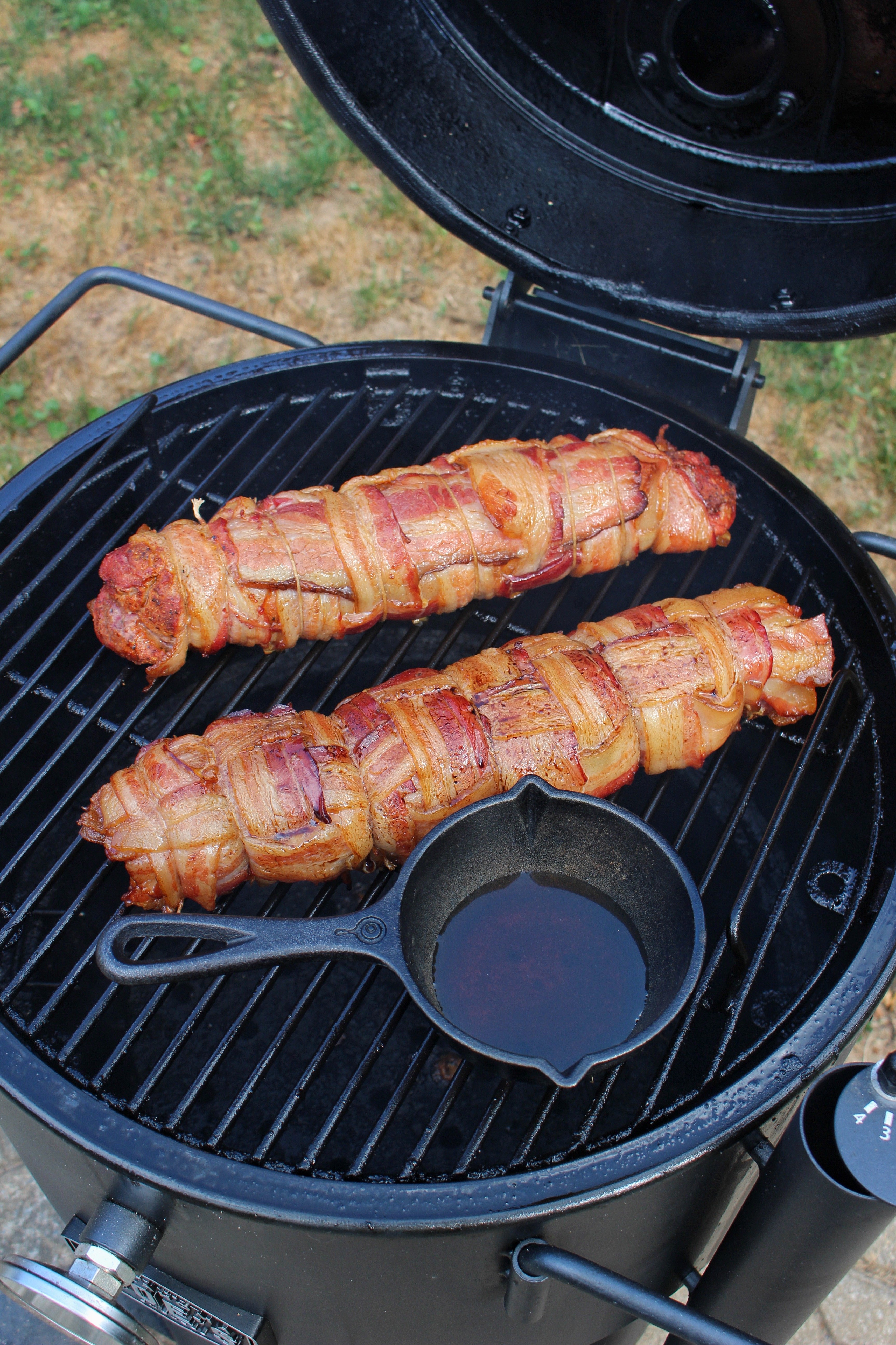 The pork on the grill being to smoke.