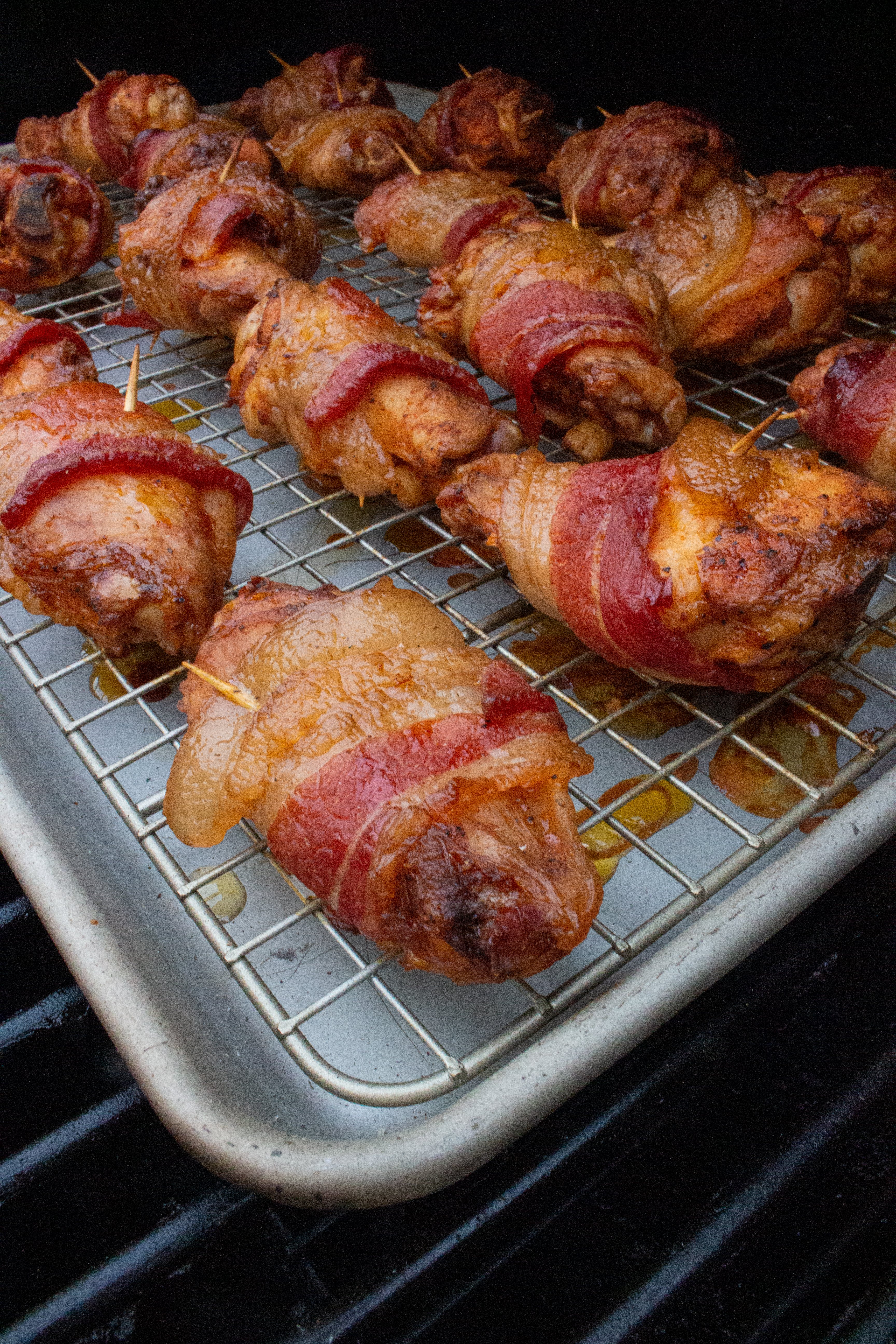 The wings smoking on the grill. 