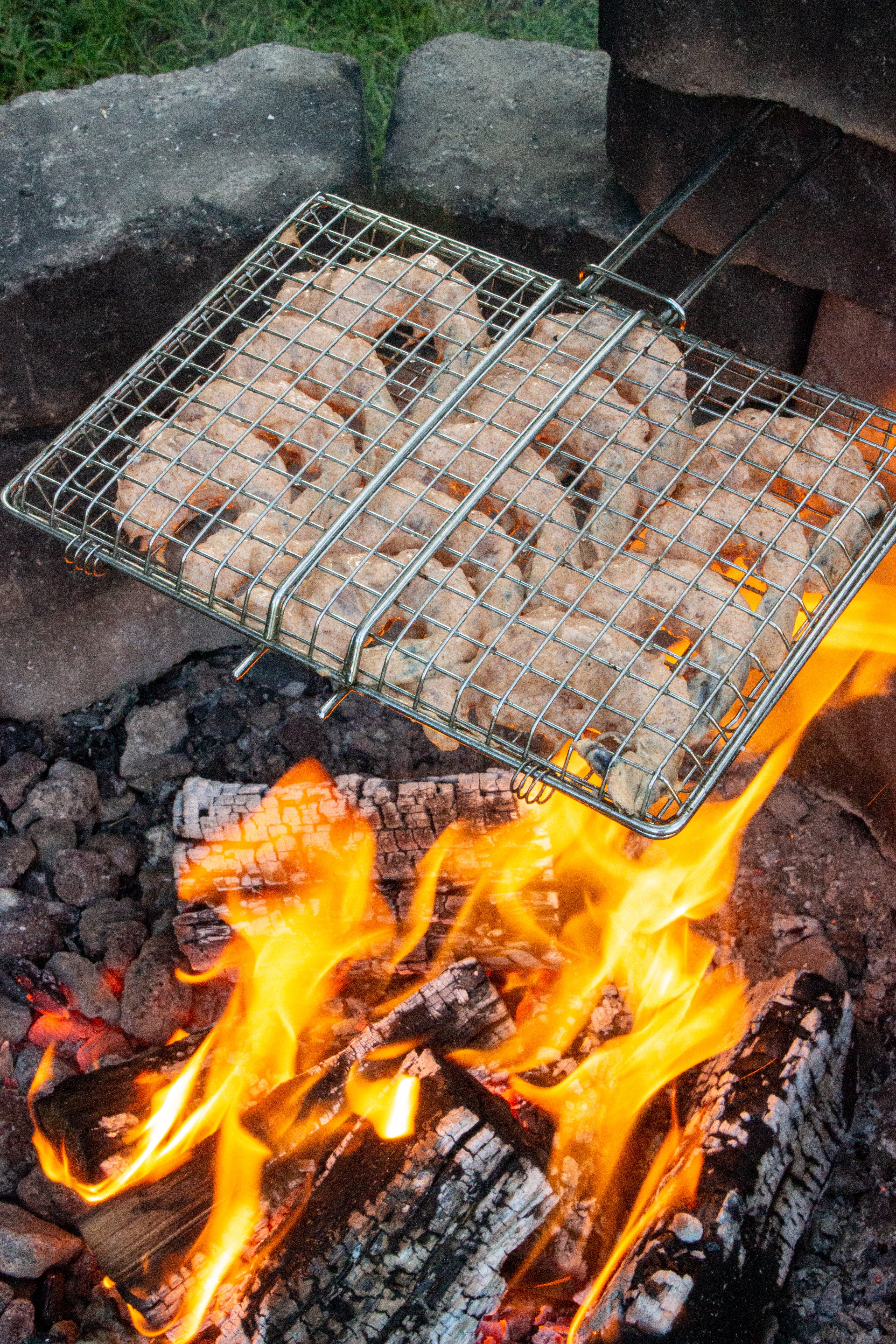 The marinated shrimp getting started over the fire.