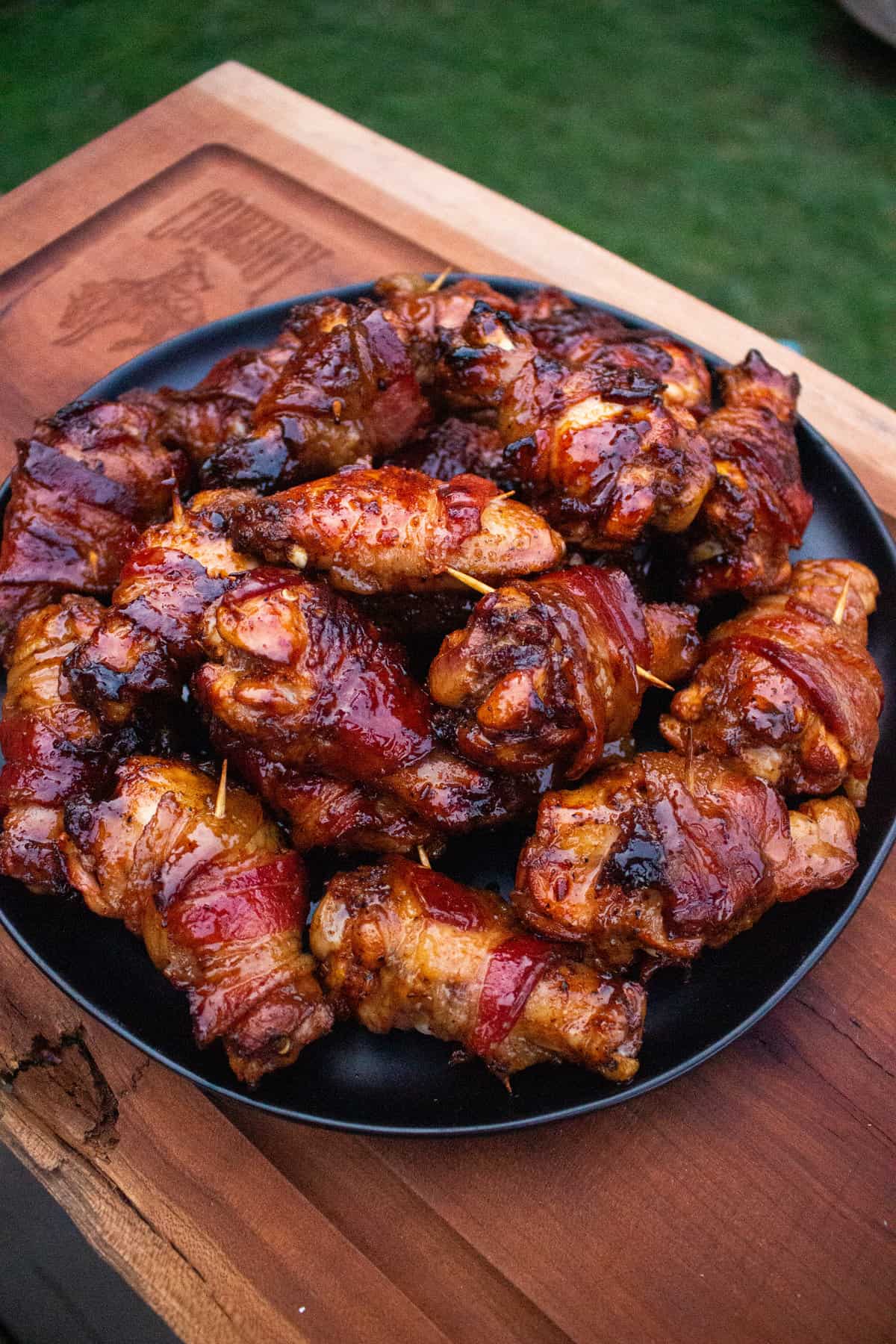 Bacon Wrapped Chicken Wings sitting on a serving platter.