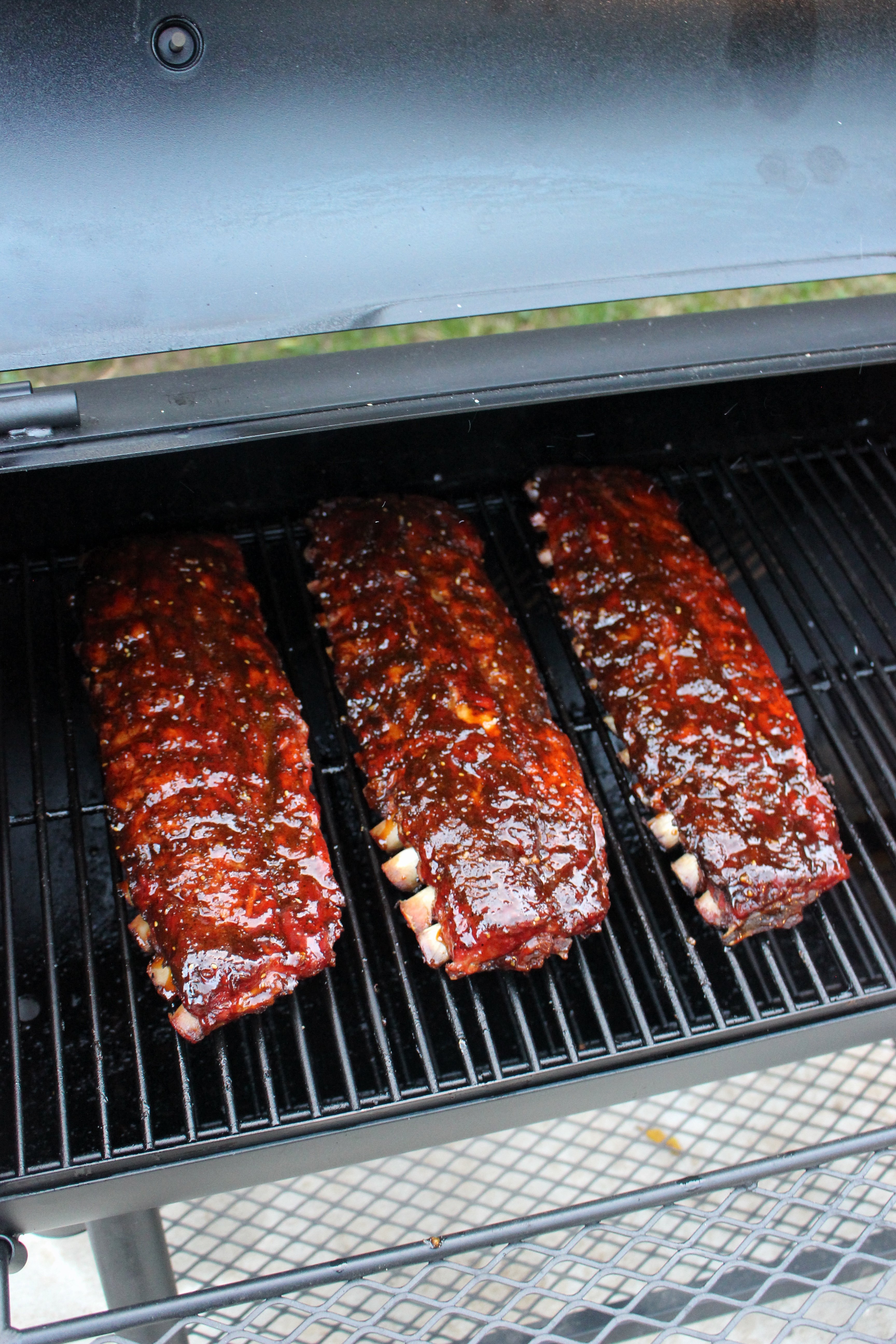 The glazed ribs on the smoker.