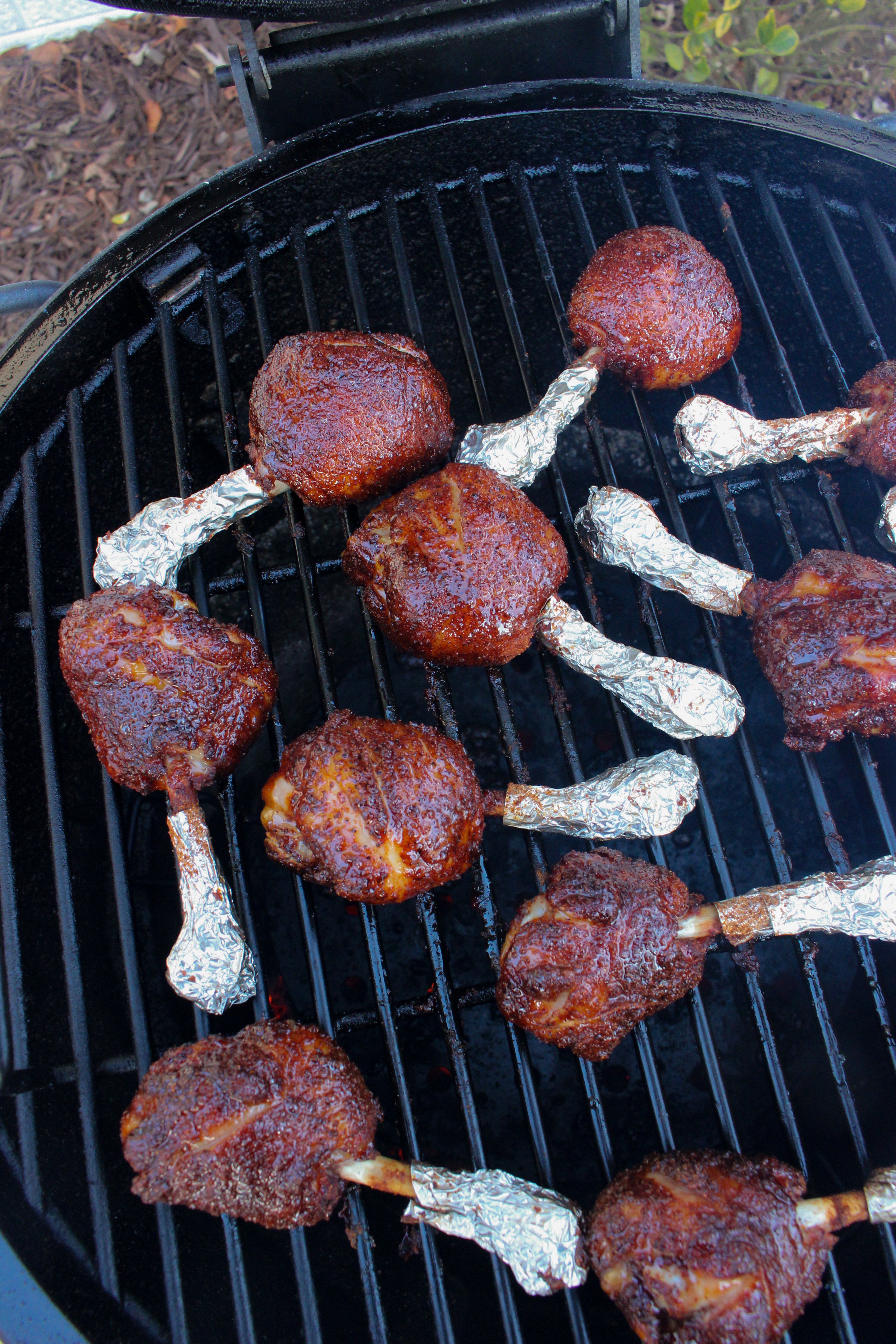 The chicken after being glazed and cooking on the grill.