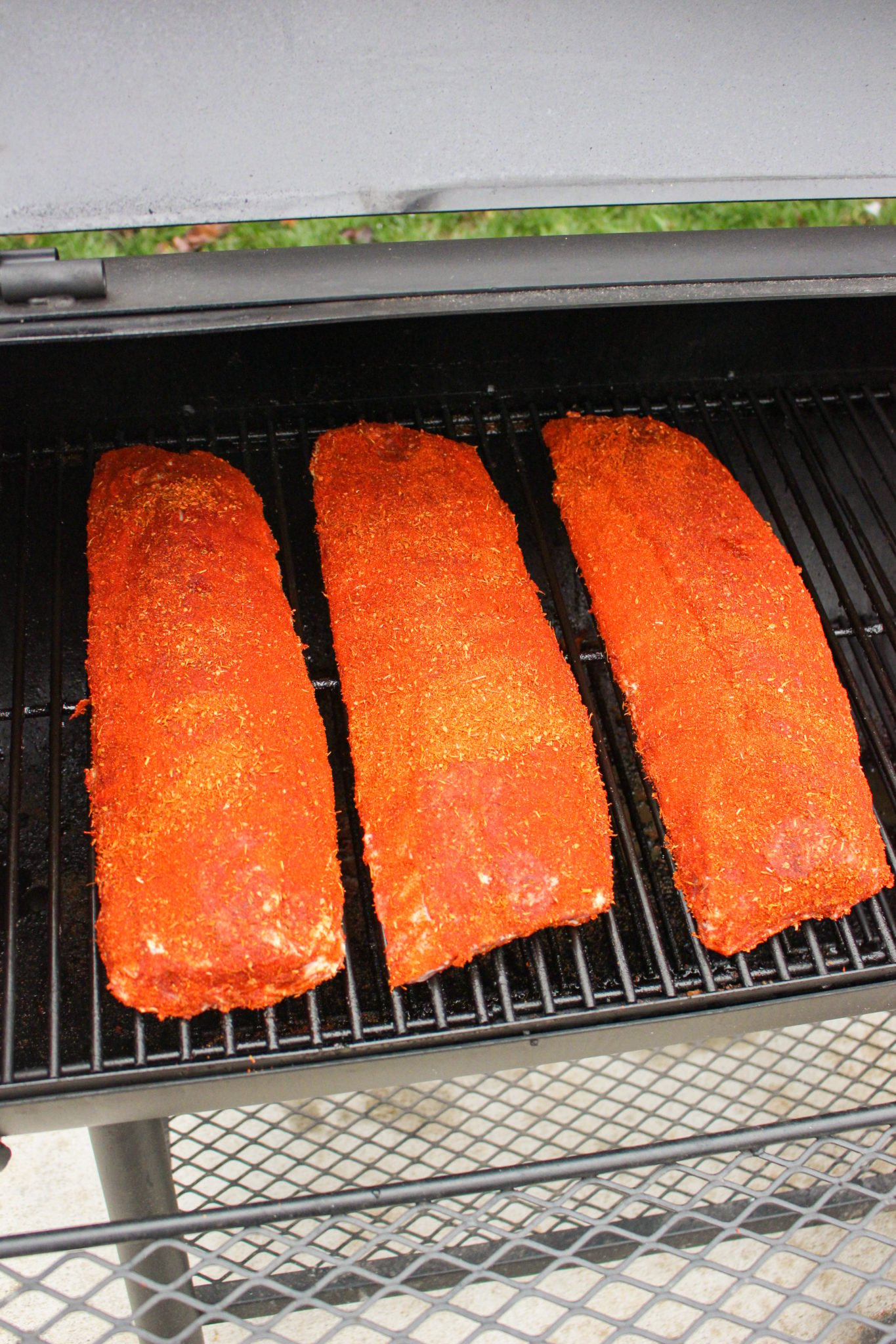 Ribs getting placed on the smoker.