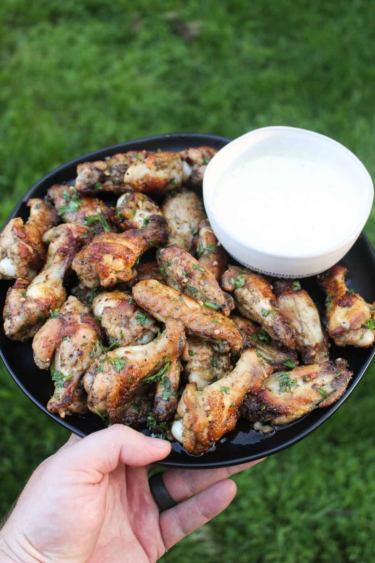 Fire Baked Chimichurri chicken wings cooked in a pizza oven ready to serve.