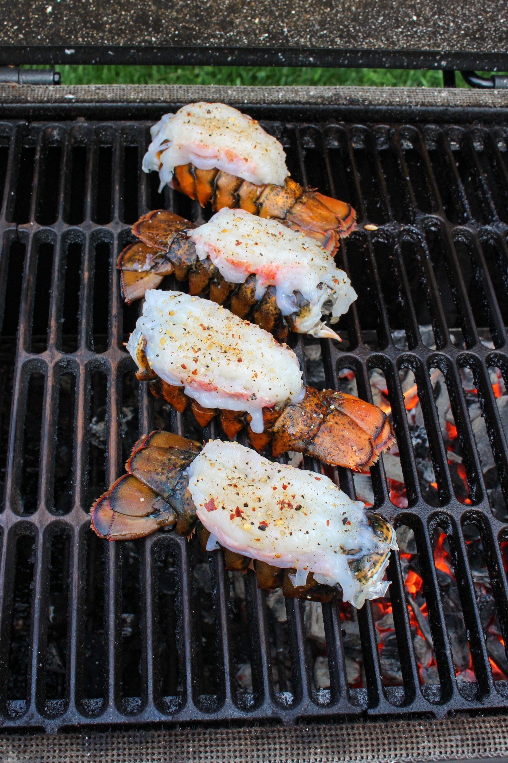 Raw lobsters hitting the grill. 