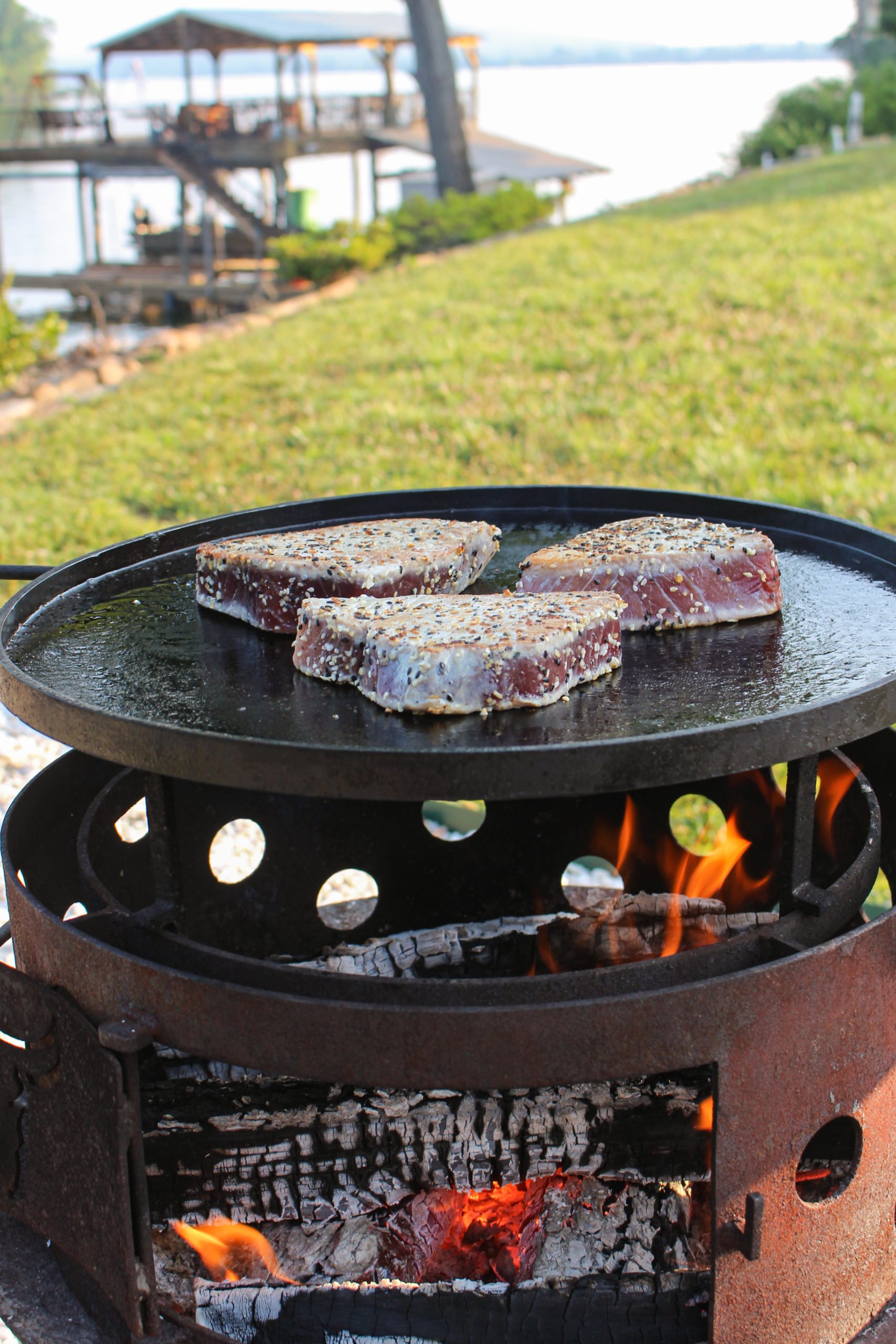 The dish seasoned and searing on the plancha. 