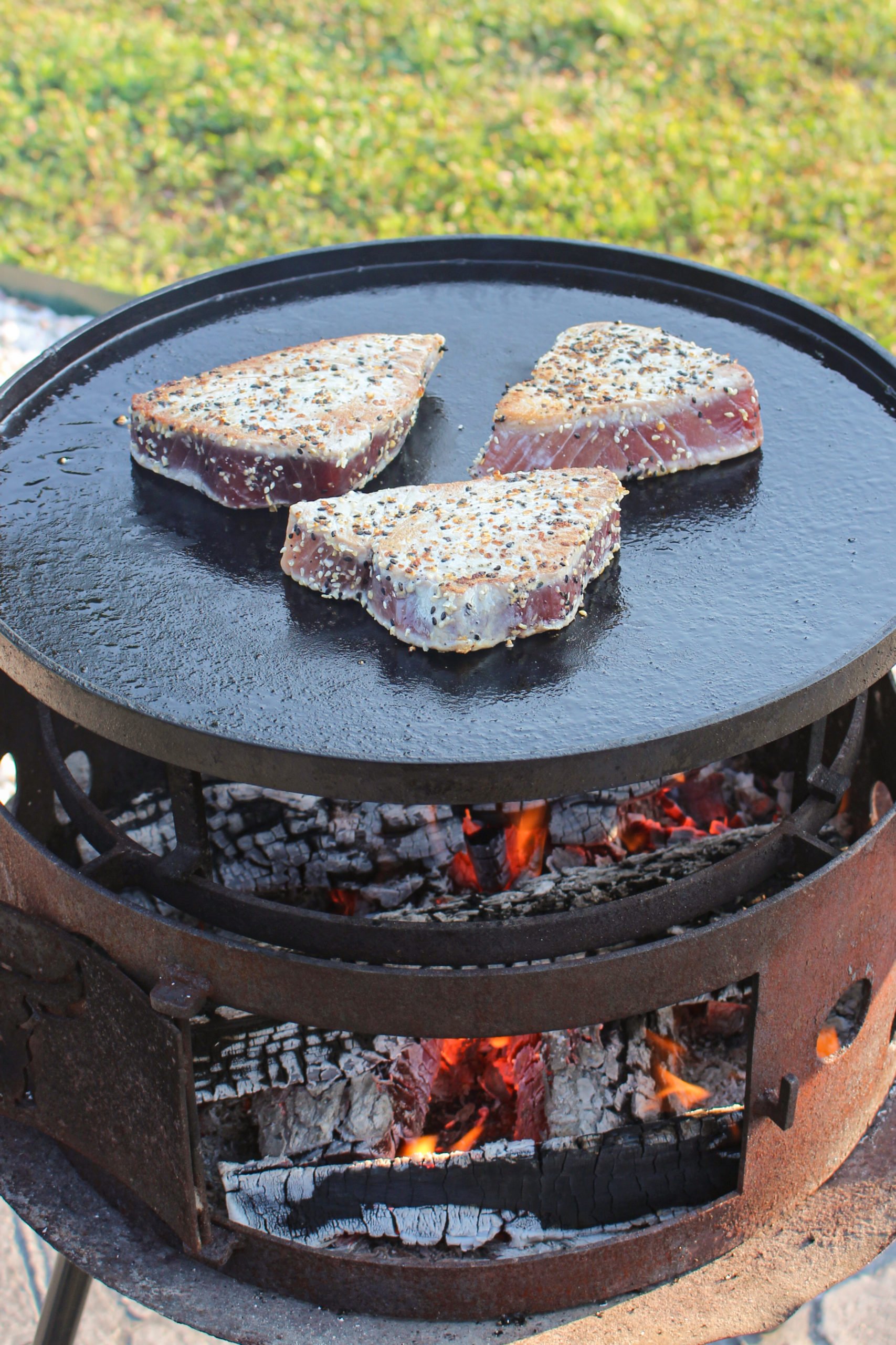 Flipping the meat to sear the other side. 