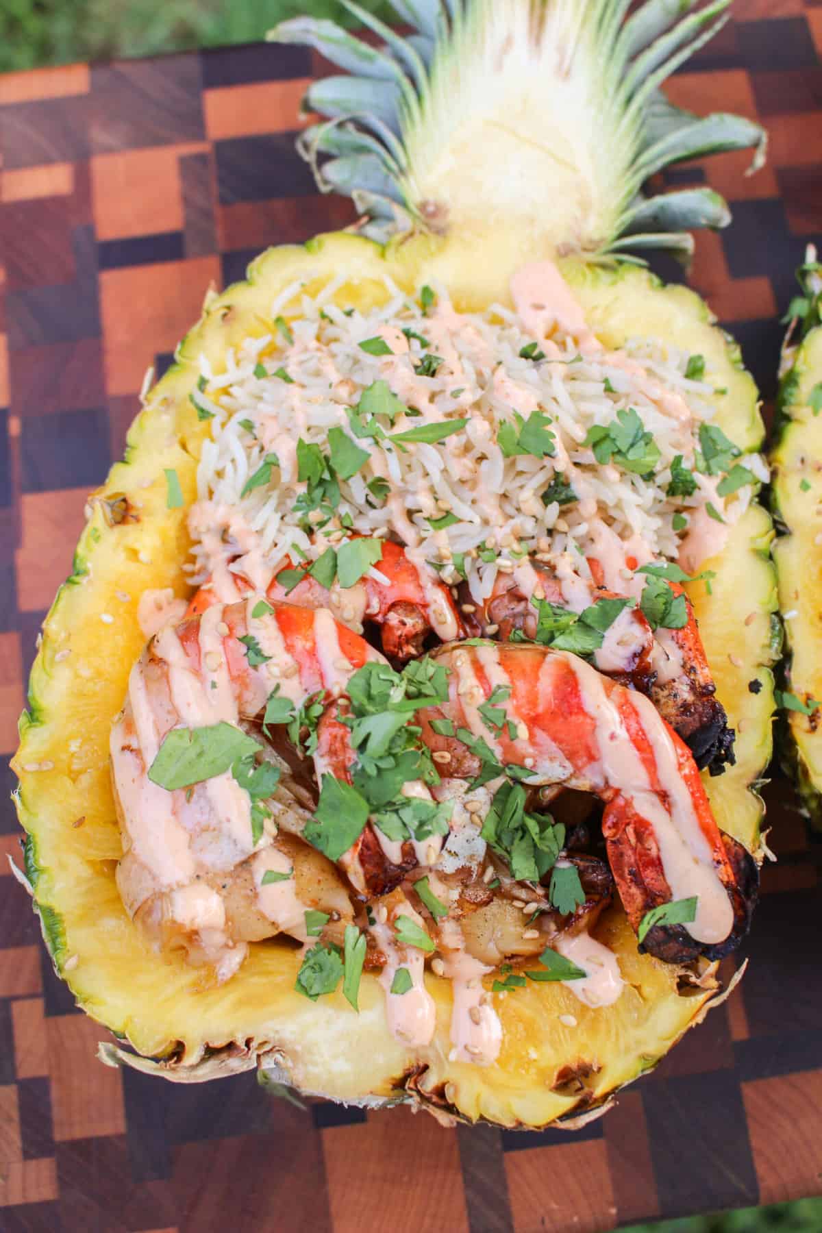 A close up shot of the pineapple shrimp bowls to show the sauce drizzle. 