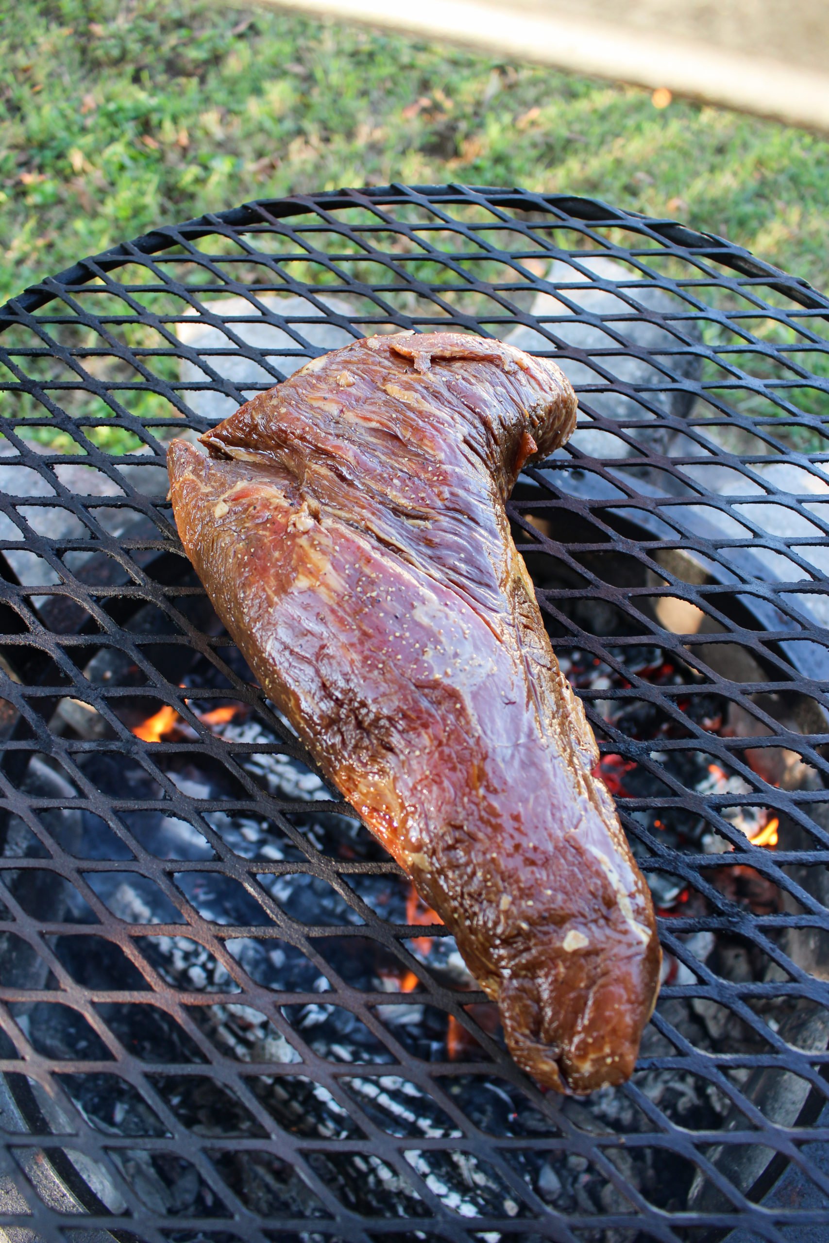 Grilled Steak with Peanut Butter Sauce hitting the grill grate