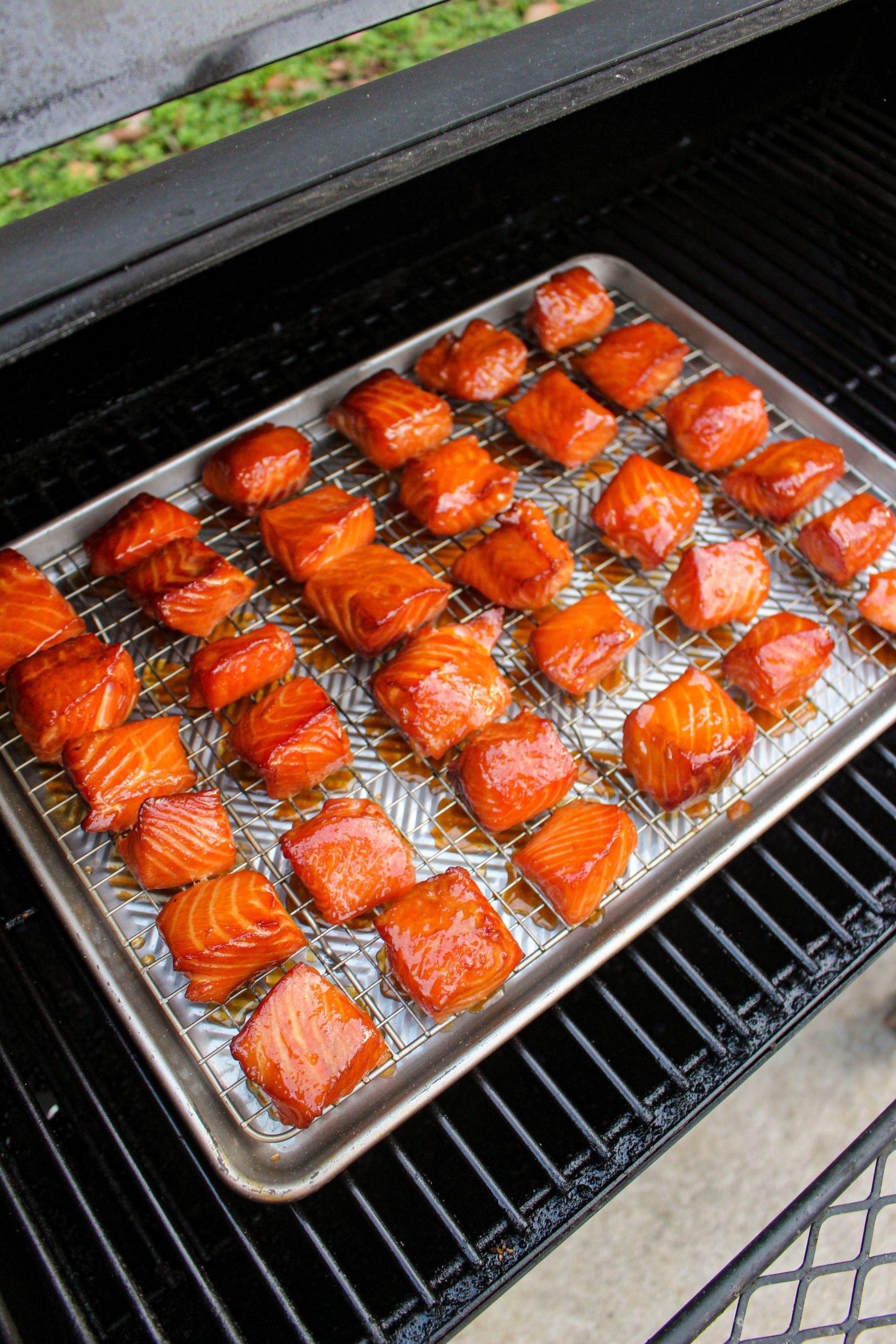 Smoked Salmon Burnt Ends get glazed.