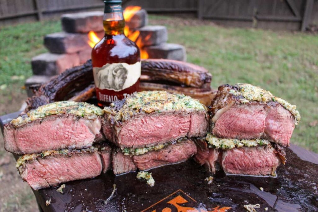 Tomahawk Steaks with French Onion Crust sliced and ready to eat.