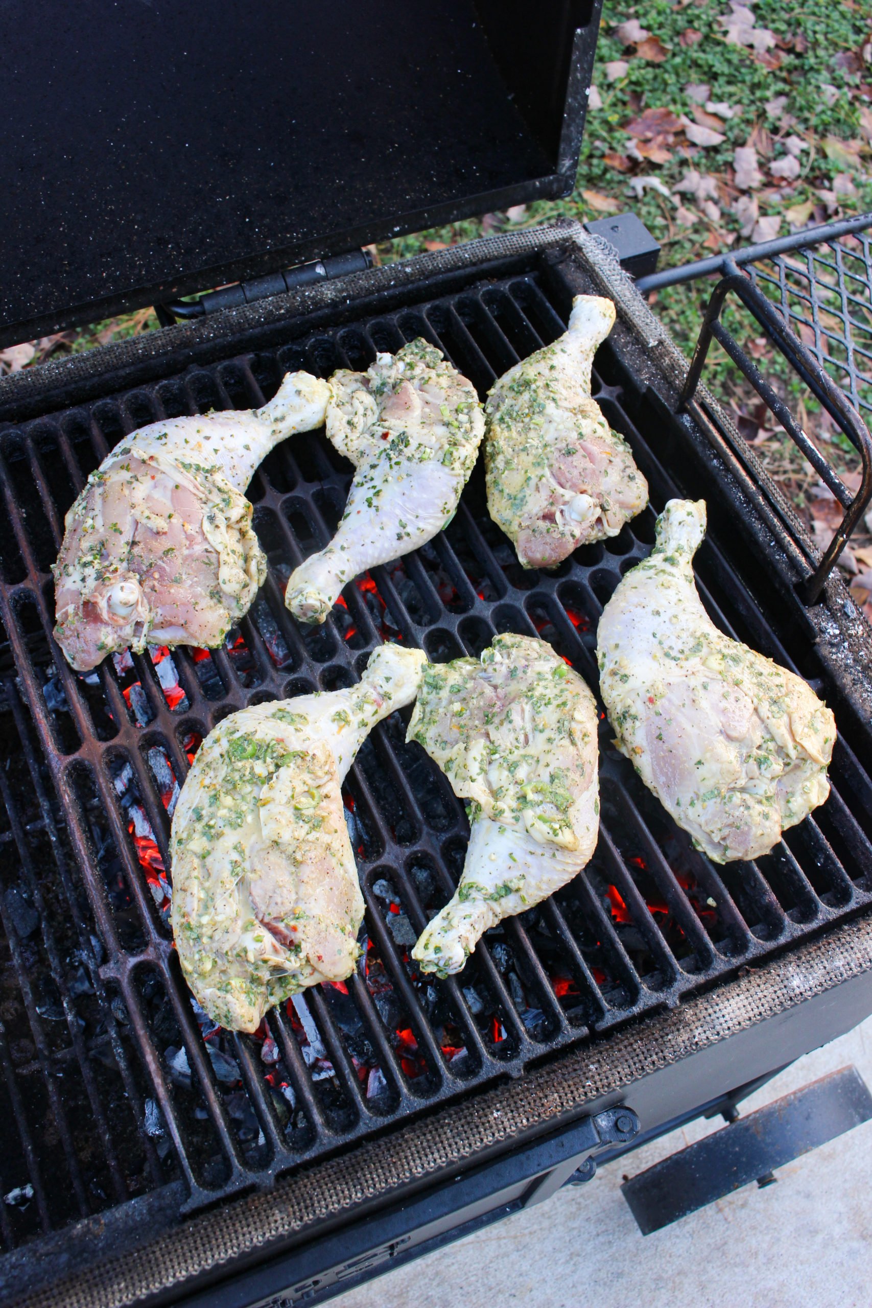 The raw meat starting to cook over the coals.