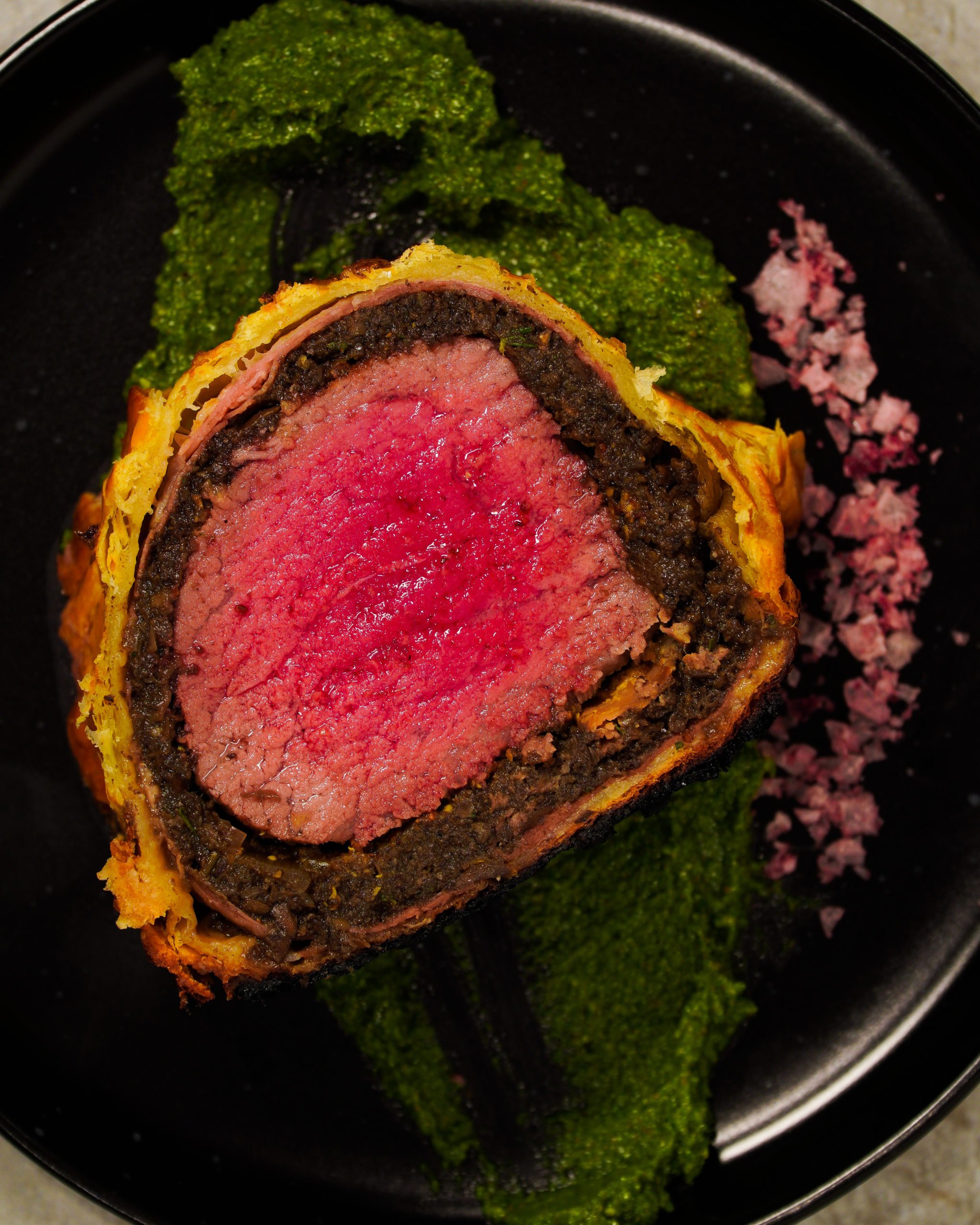 Bourbon Beef Wellington sliced, plated and served.