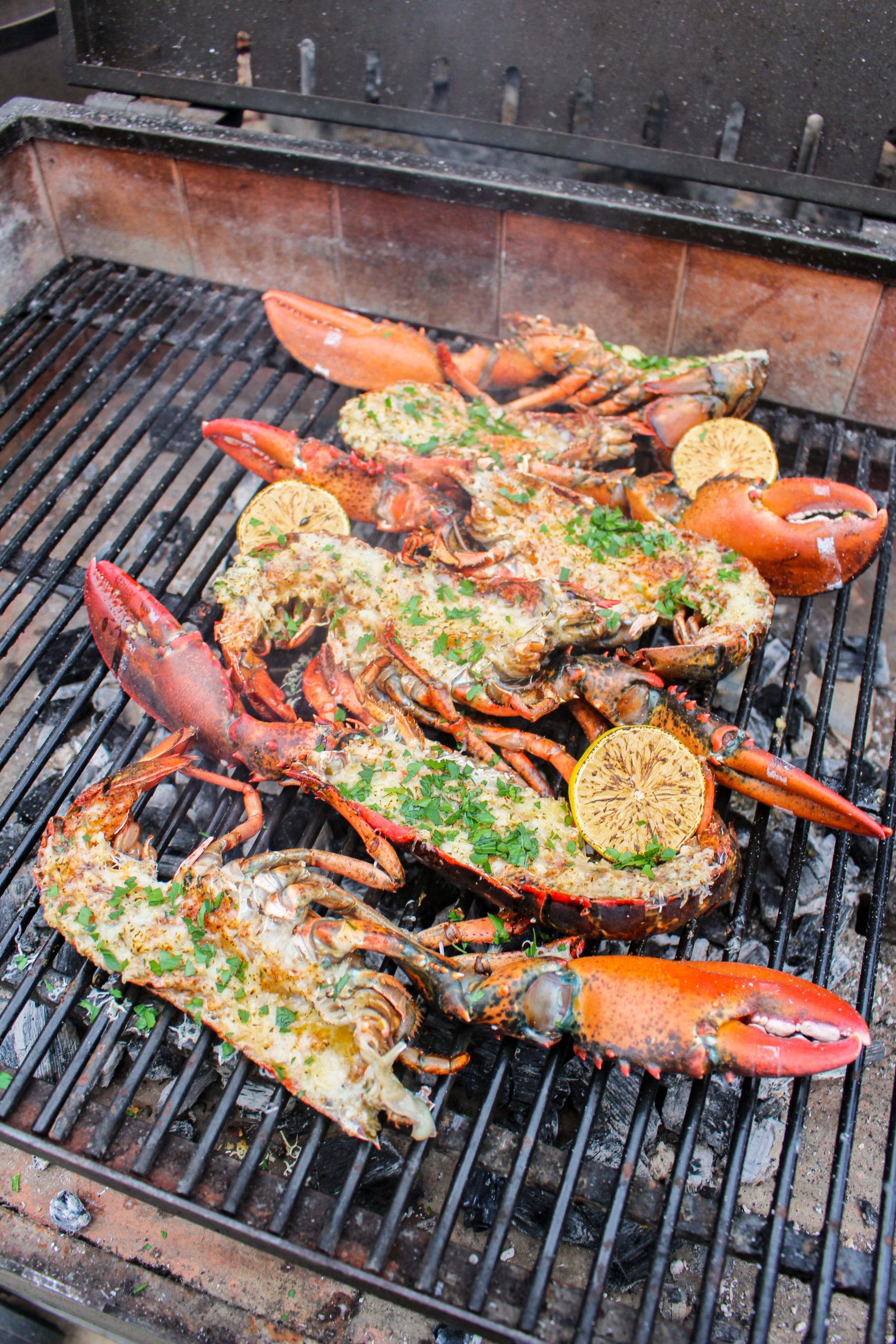 Grilled Garlic Butter Lobster with cheese and chopped parsley.