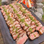Brazilian Steaks with Habanero Chimichurri sliced and topped with the chimichurri.