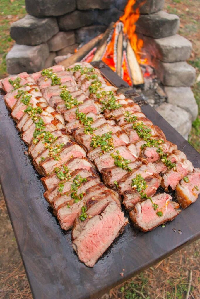 Brazilian Steaks with Habanero Chimichurri sliced and topped with the chimichurri.