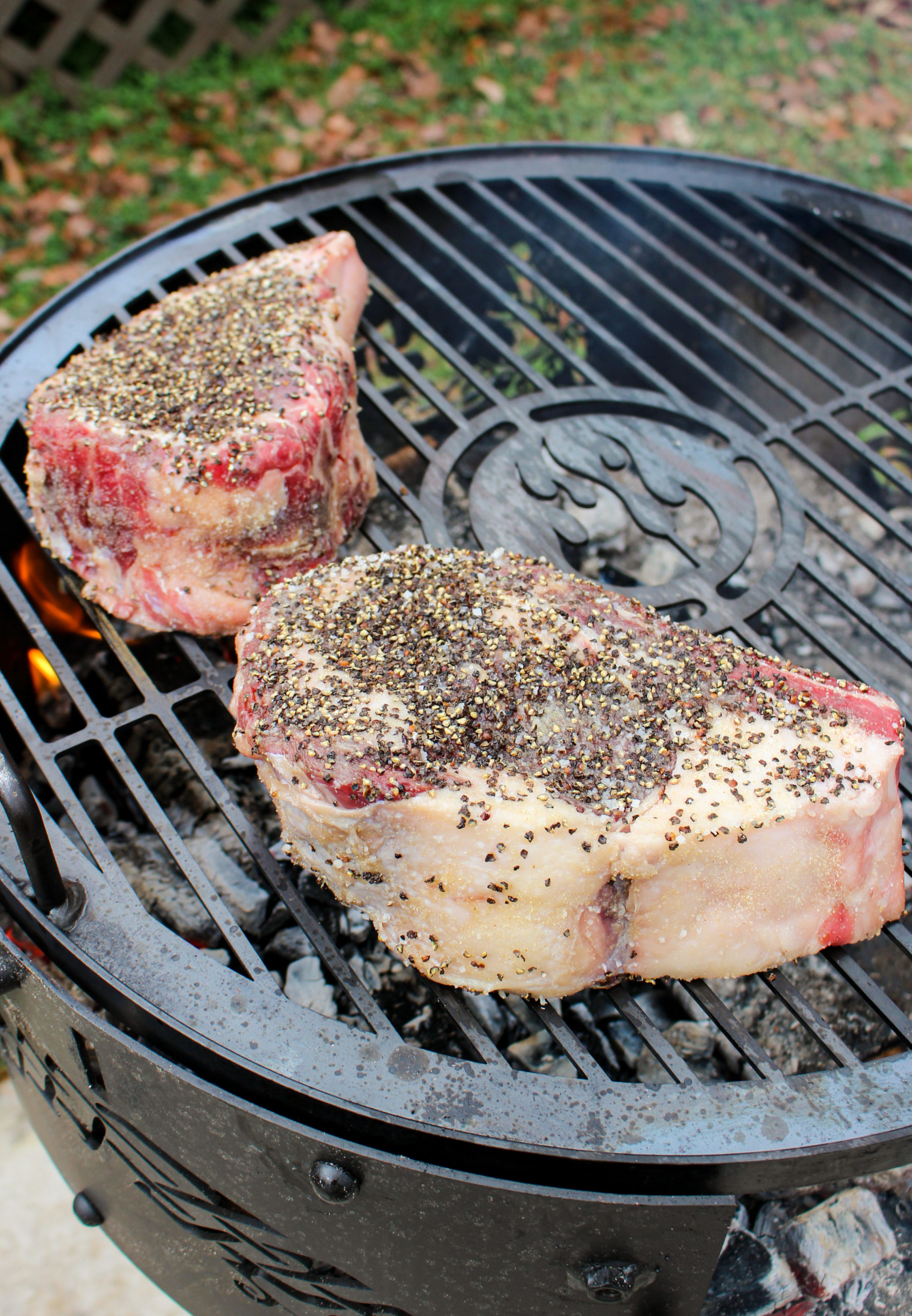 Peppercorn Crusted Steaks getting placed on the grill. 