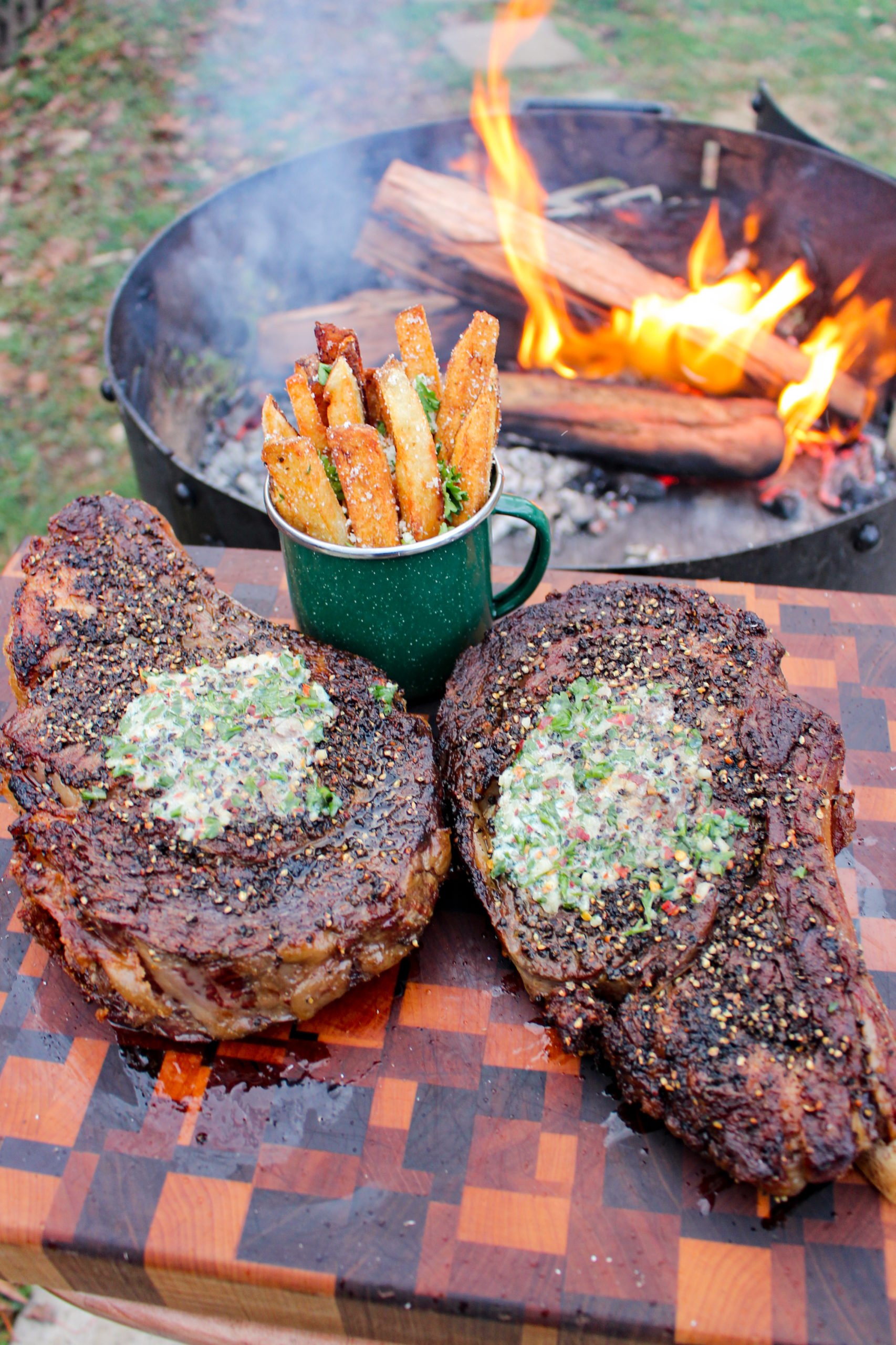 The ribeyes resting with the herb butter melting on top of them. 