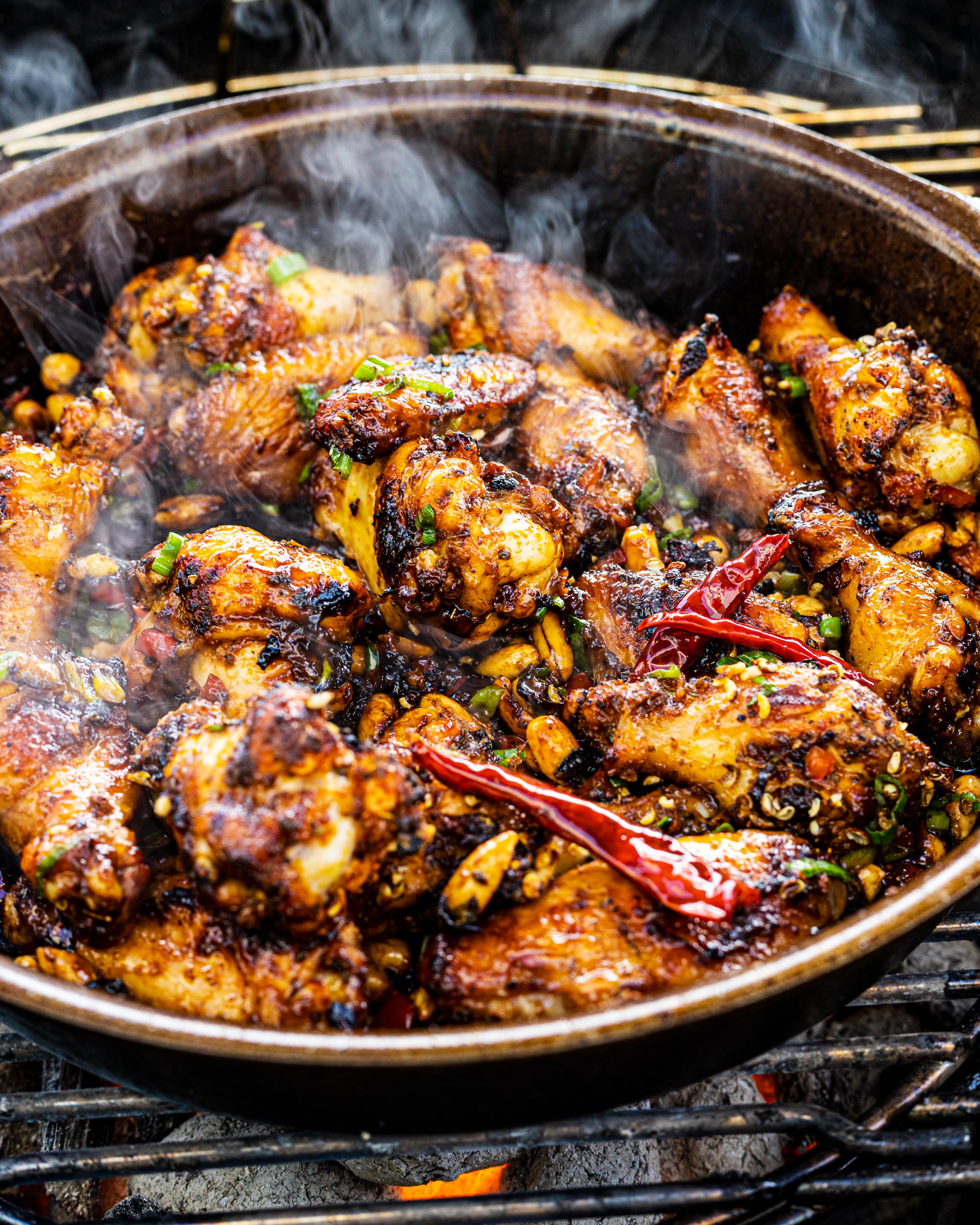 Grilled Kung Pao Chicken Wings sizzling in the skillet.