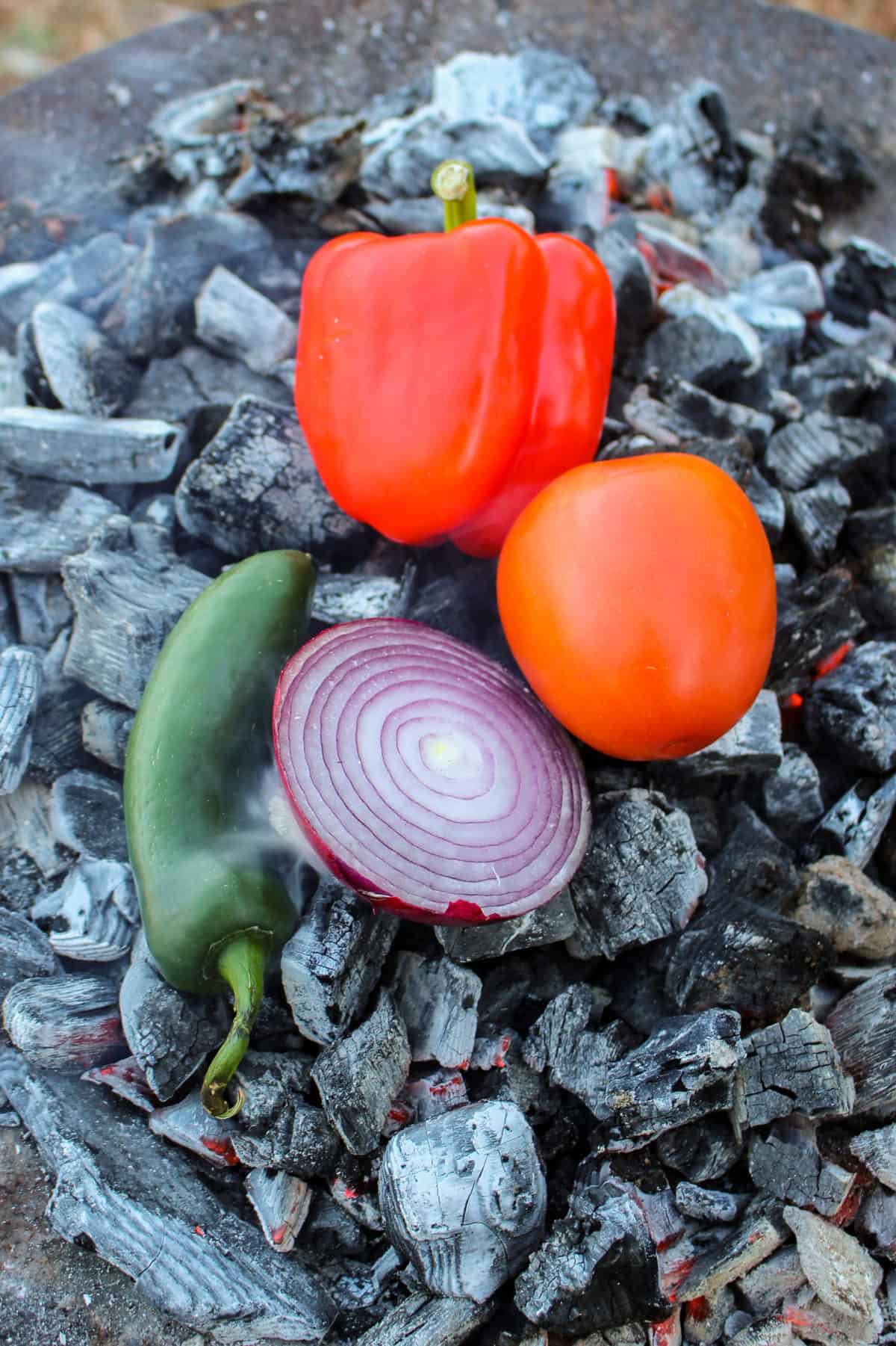 Roasting our veggies on the coals to make the perfect Loaded Steak Fries salsa.