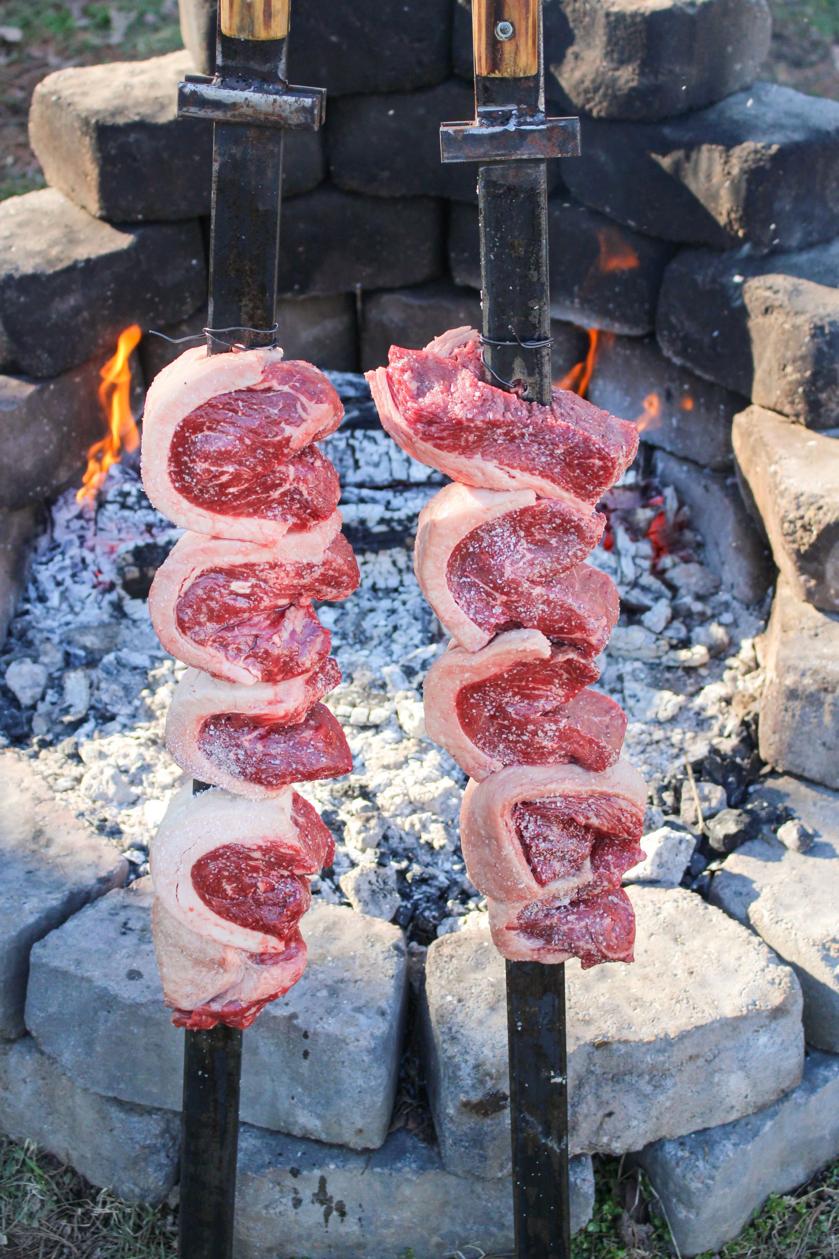 Churrasco Picanha gets situated by the fire.