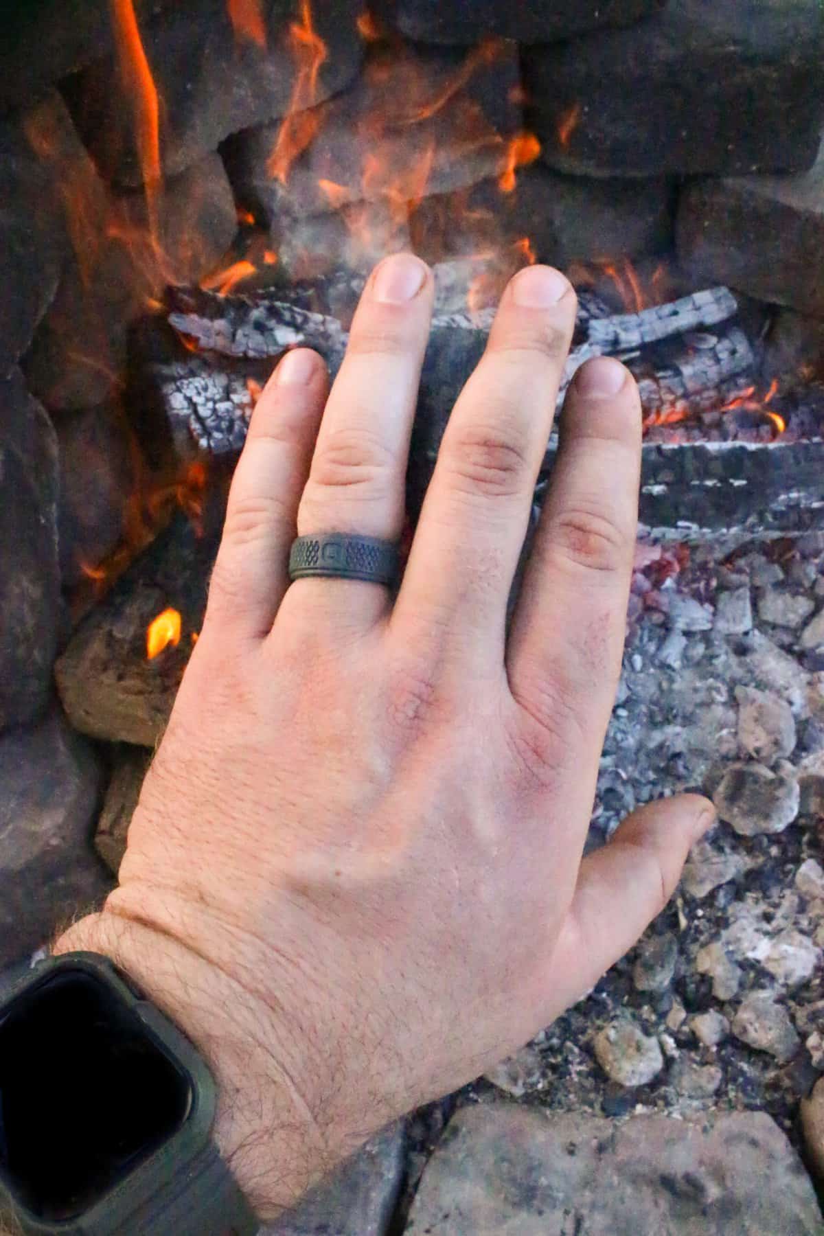 Showing the QALO ring with fire in the background.