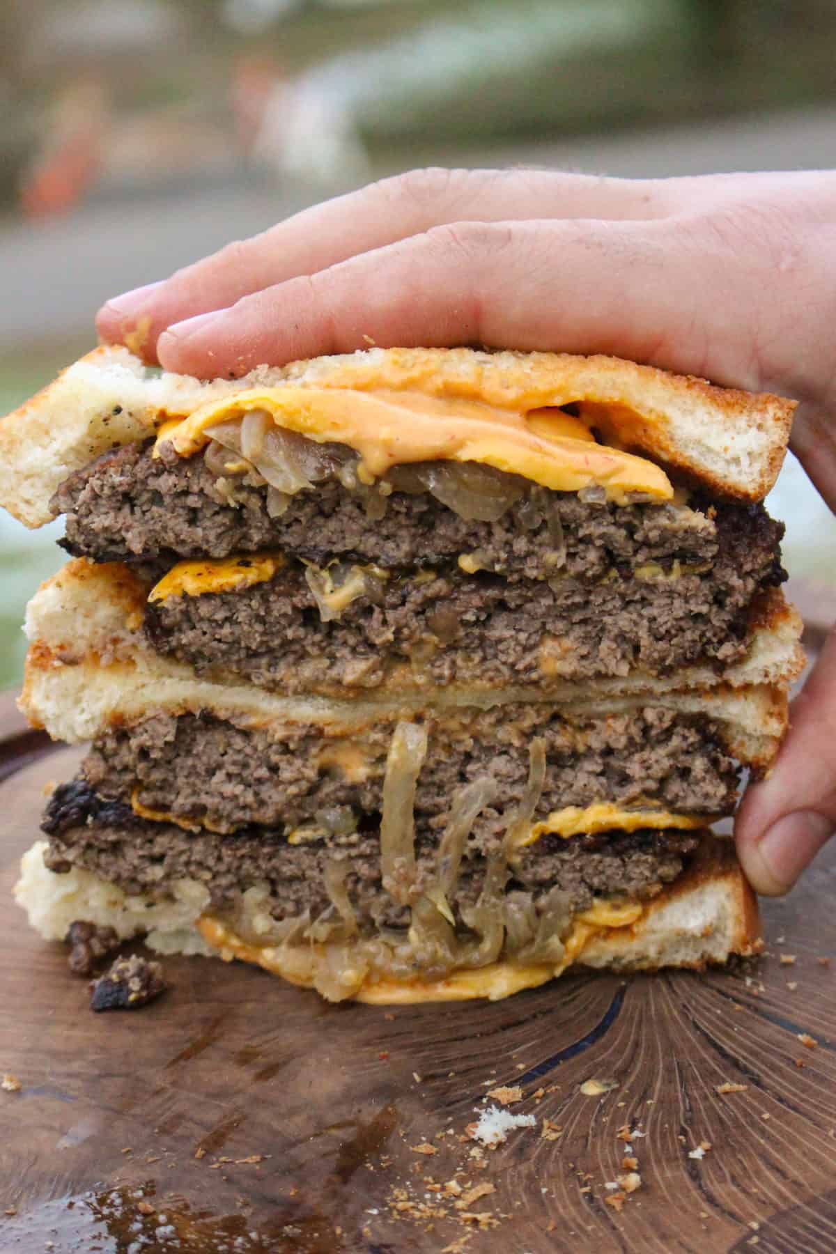 Chopped Texas Patty Melt sliced and held up to the camera.