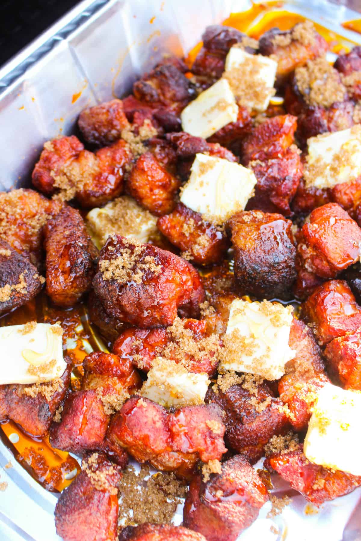 Adding butter, brown sugar and honey to the burnt ends.
