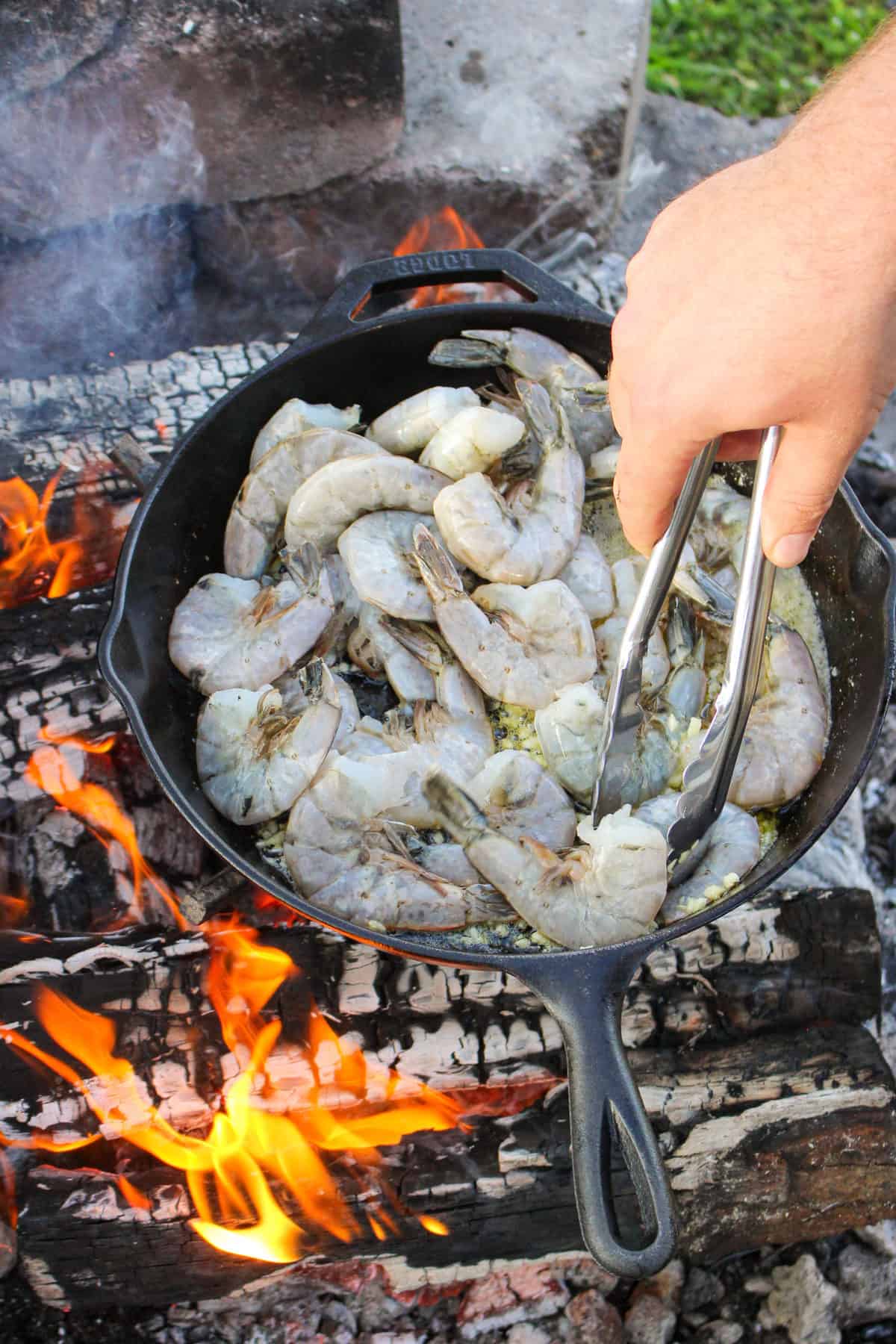 Shrimp starting to cook in the skillet.