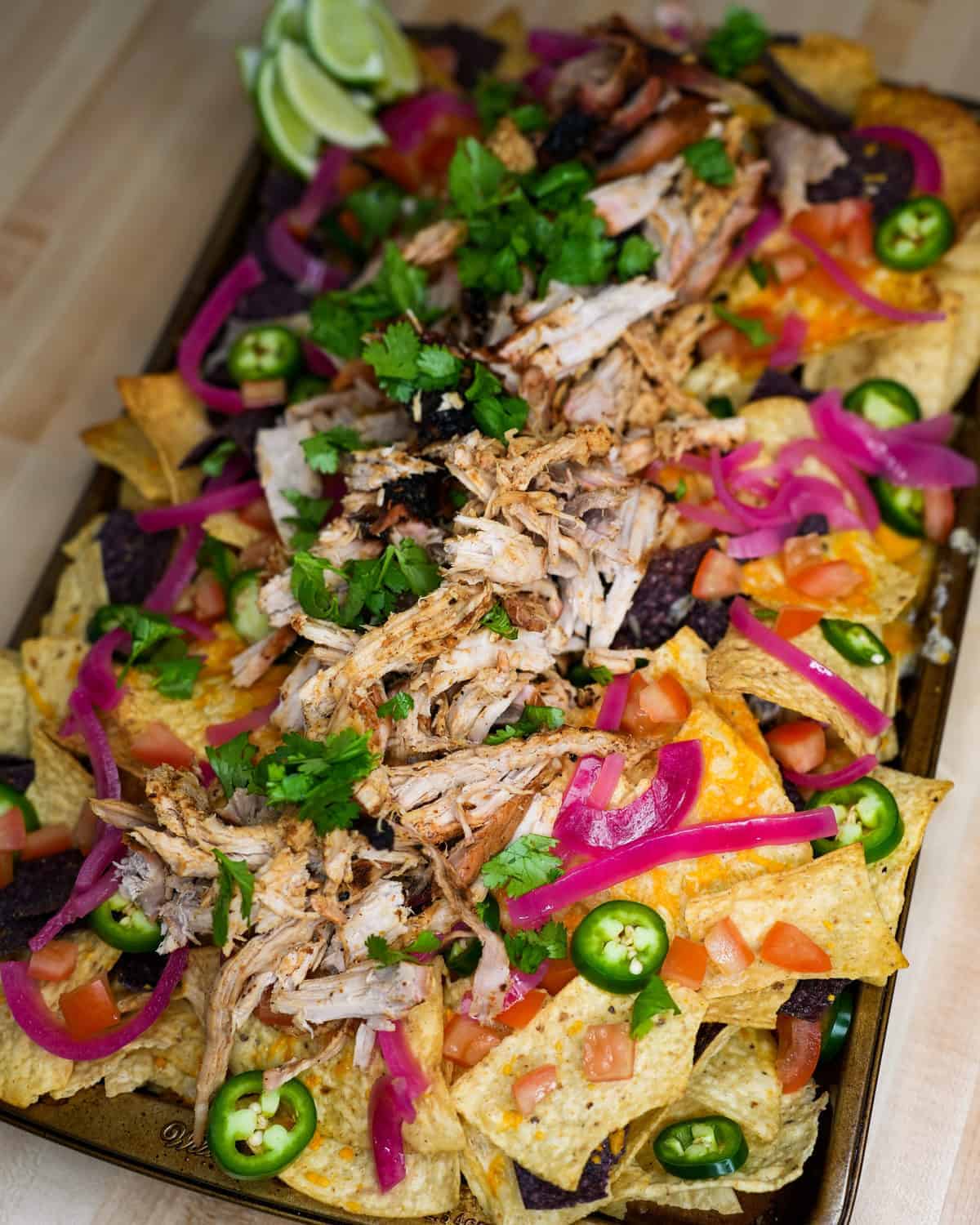 Pulled Pork Nachos with all the toppings and ready to eat!