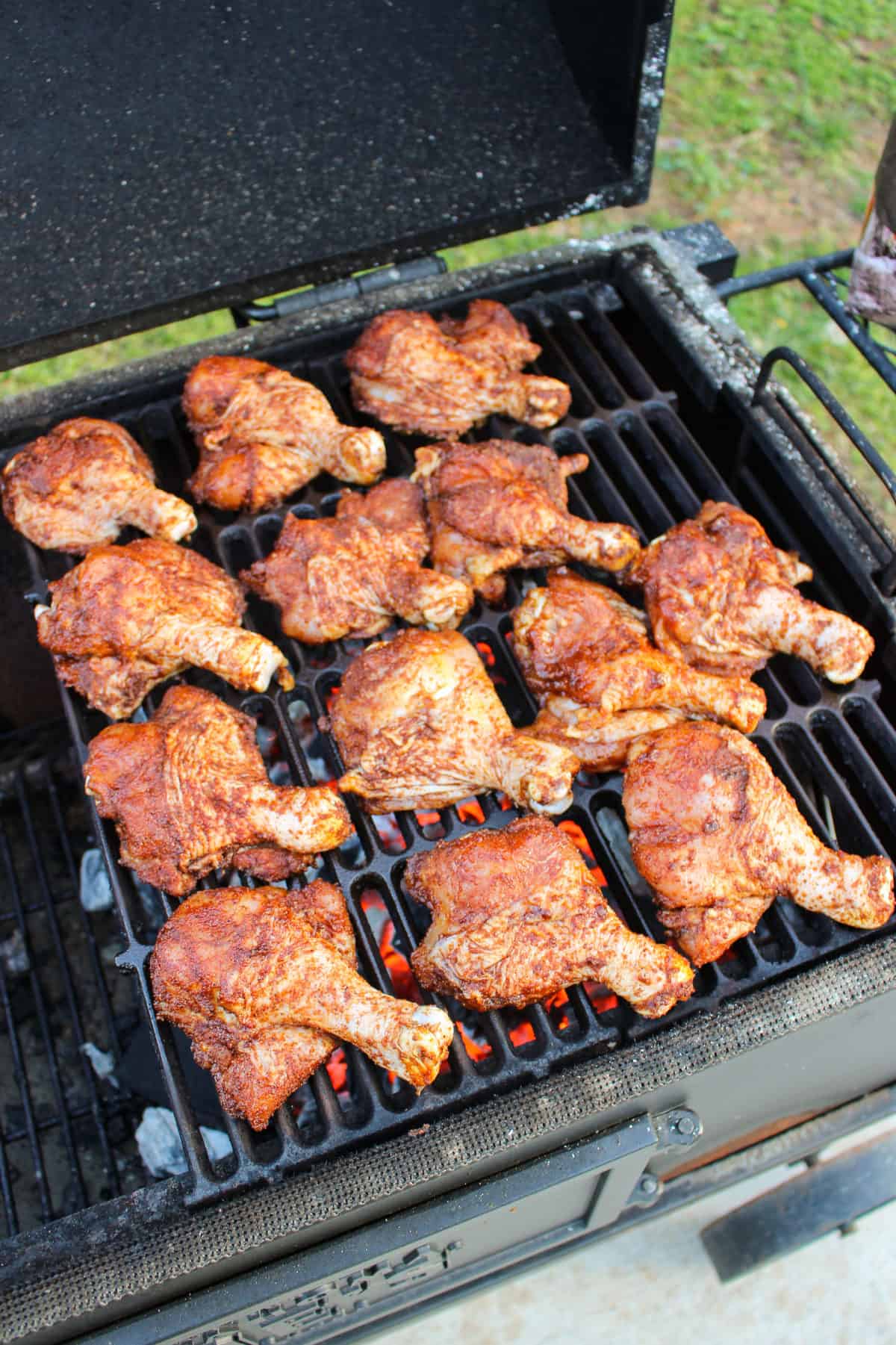 chicken drumsticks lined on a grill from above