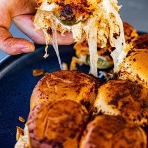 A Nashville Hot Chicken Slider getting pulled from the serving platter.