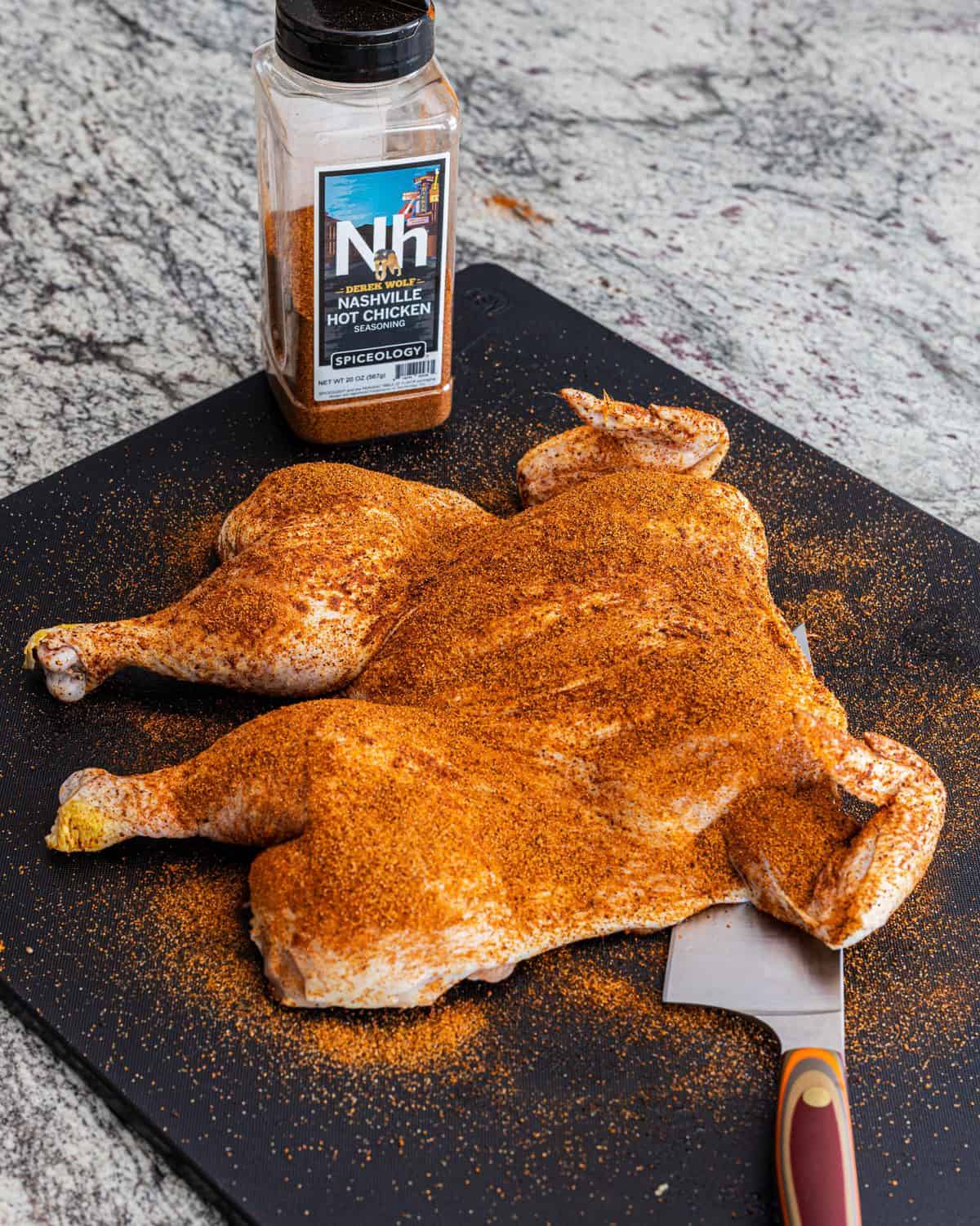 Spatchcocked chicken covered in Nashville Hot seasoning.