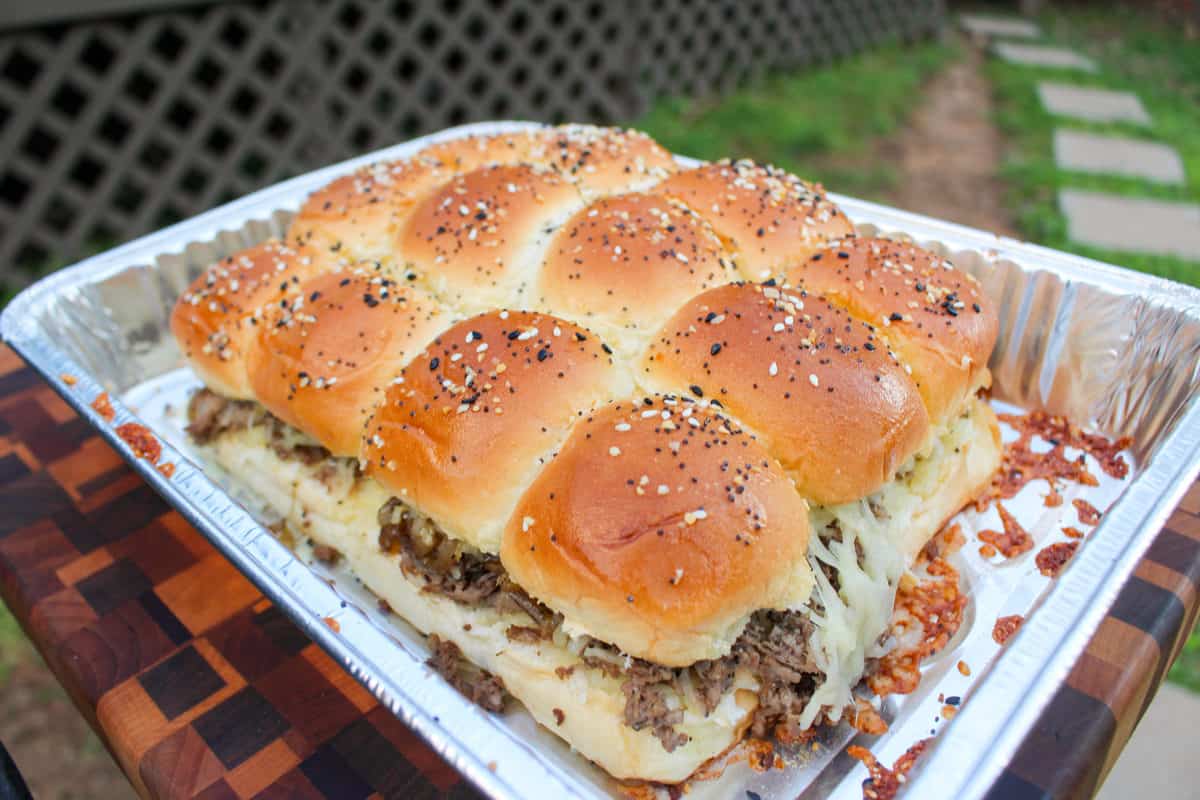Smoked Cheesesteak Sliders pulled from the smoker and ready to slice and serve.