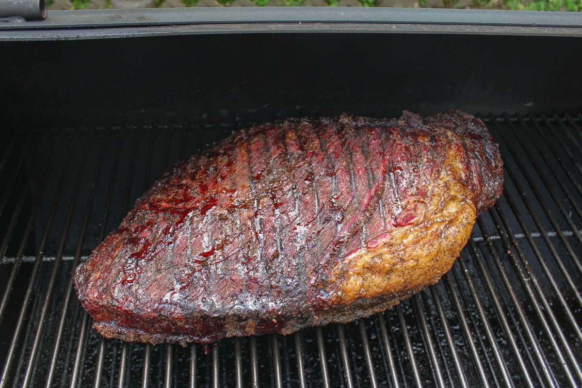 The brisket sitting on the smoker, ready to be wrapped.