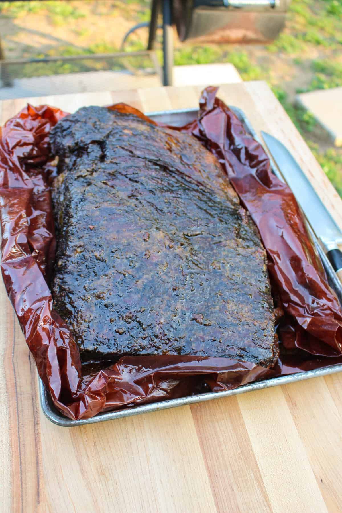 Texas Smoked Brisket getting unwrapped after it has rested.
