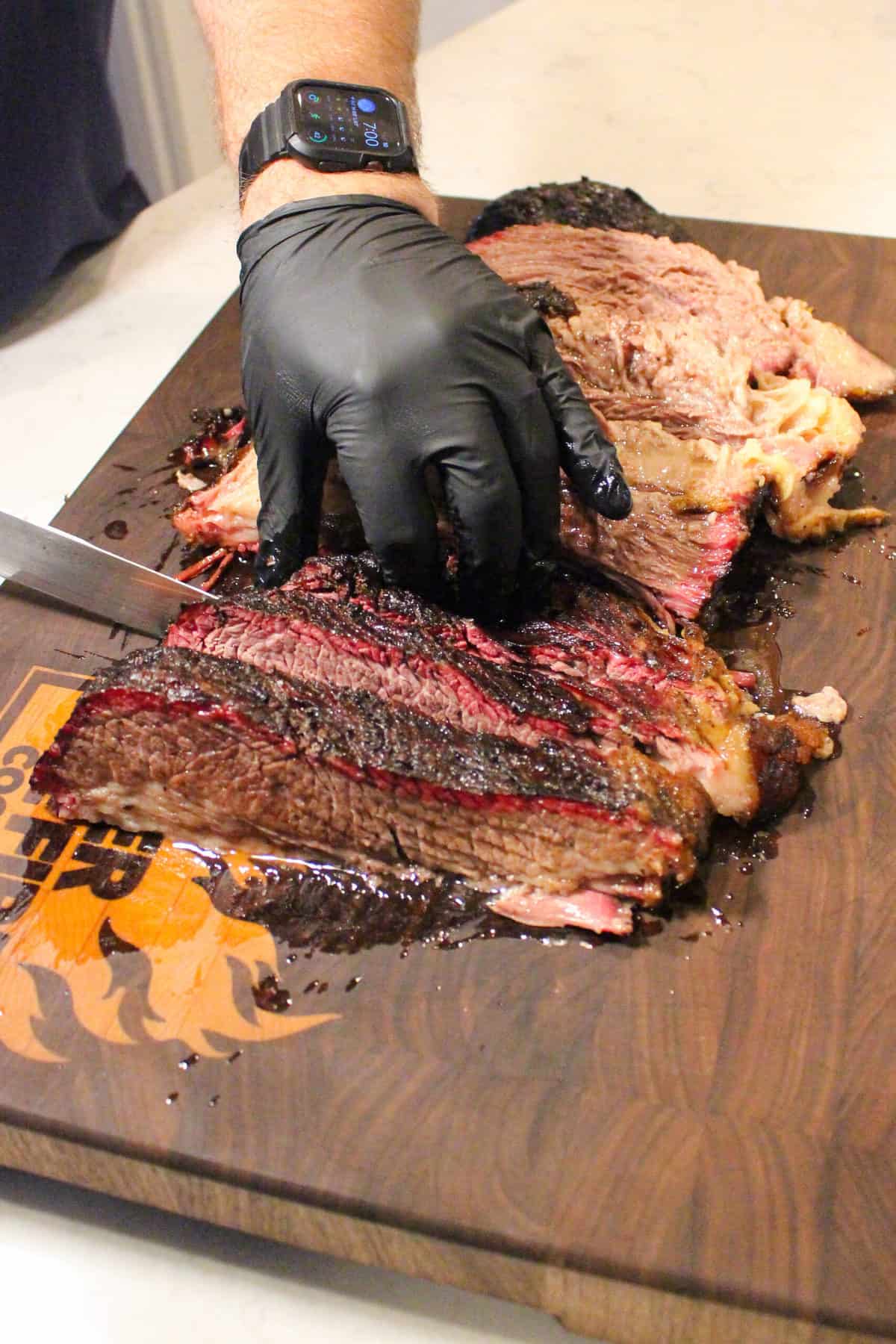 The beef brisket being sliced.