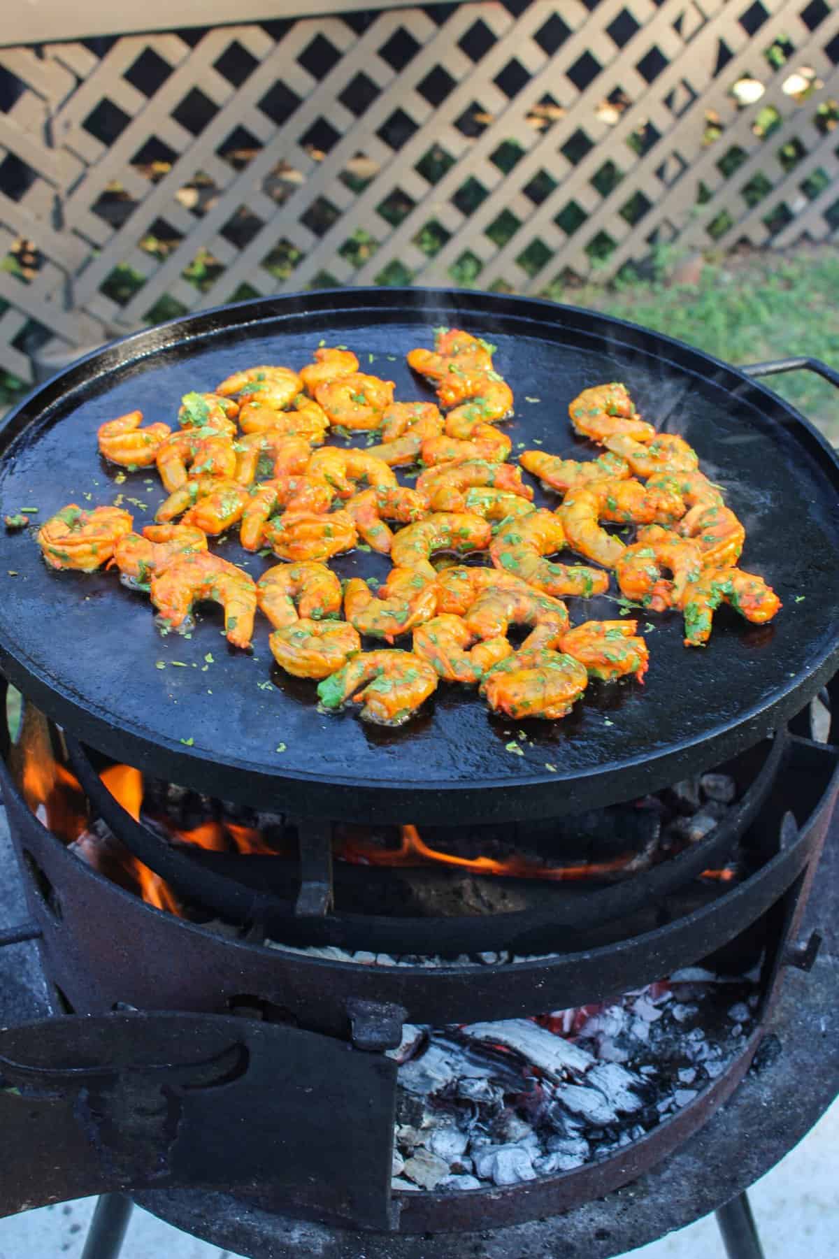 shrimp being cooked on a large plancha
