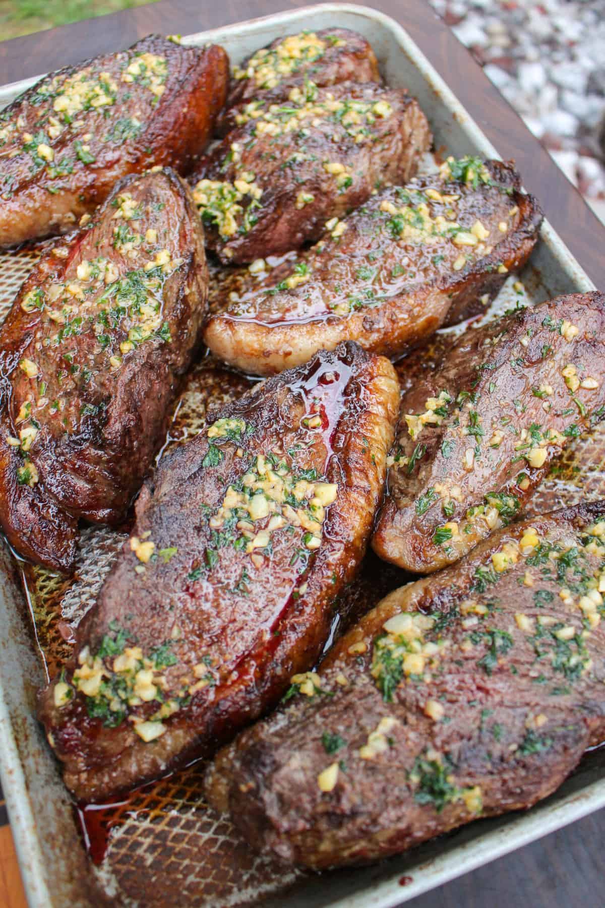 closeup of grilled garlic butter picanha in a serving dish