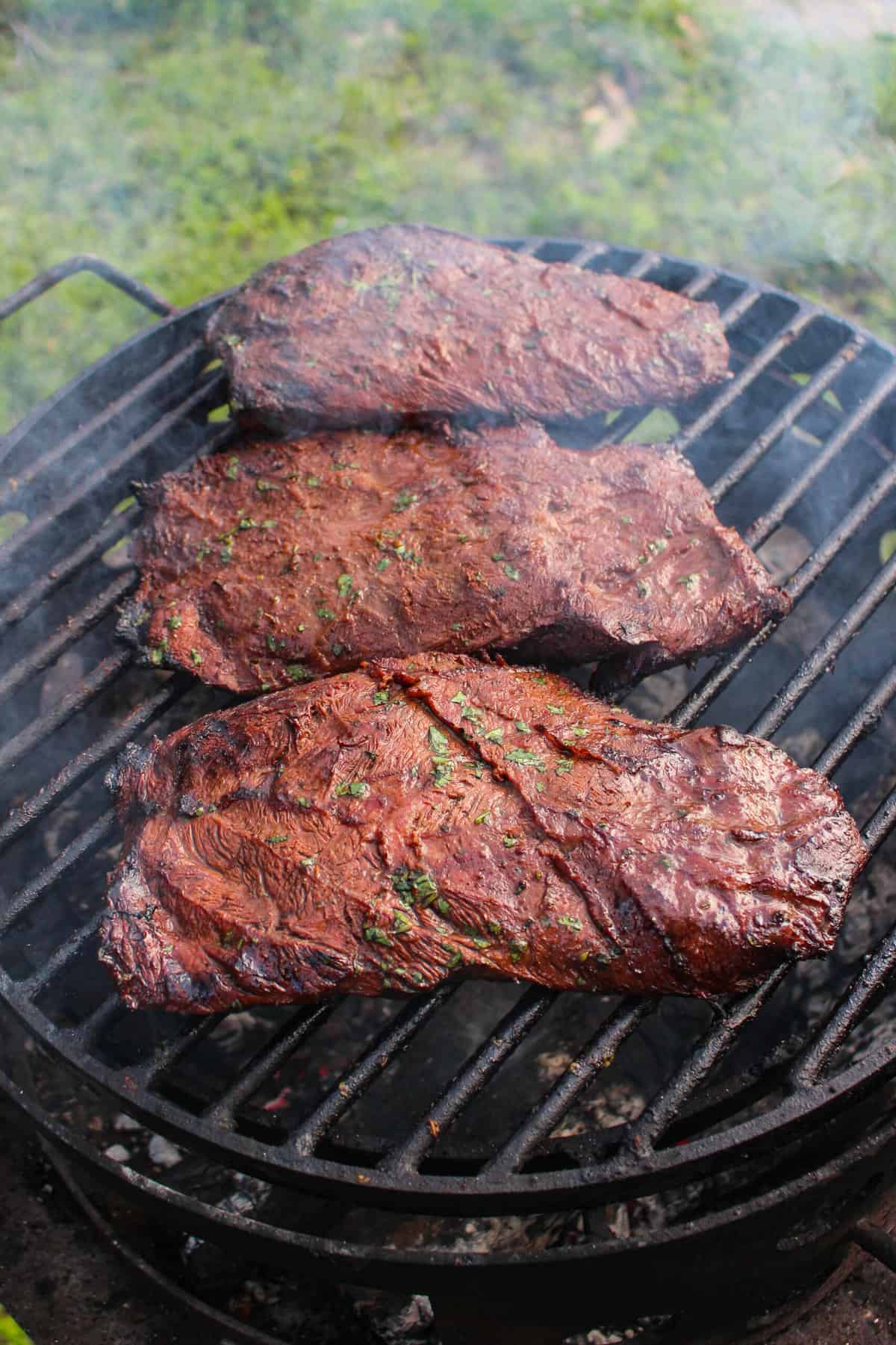 grilled flat iron steaks on a hot grill