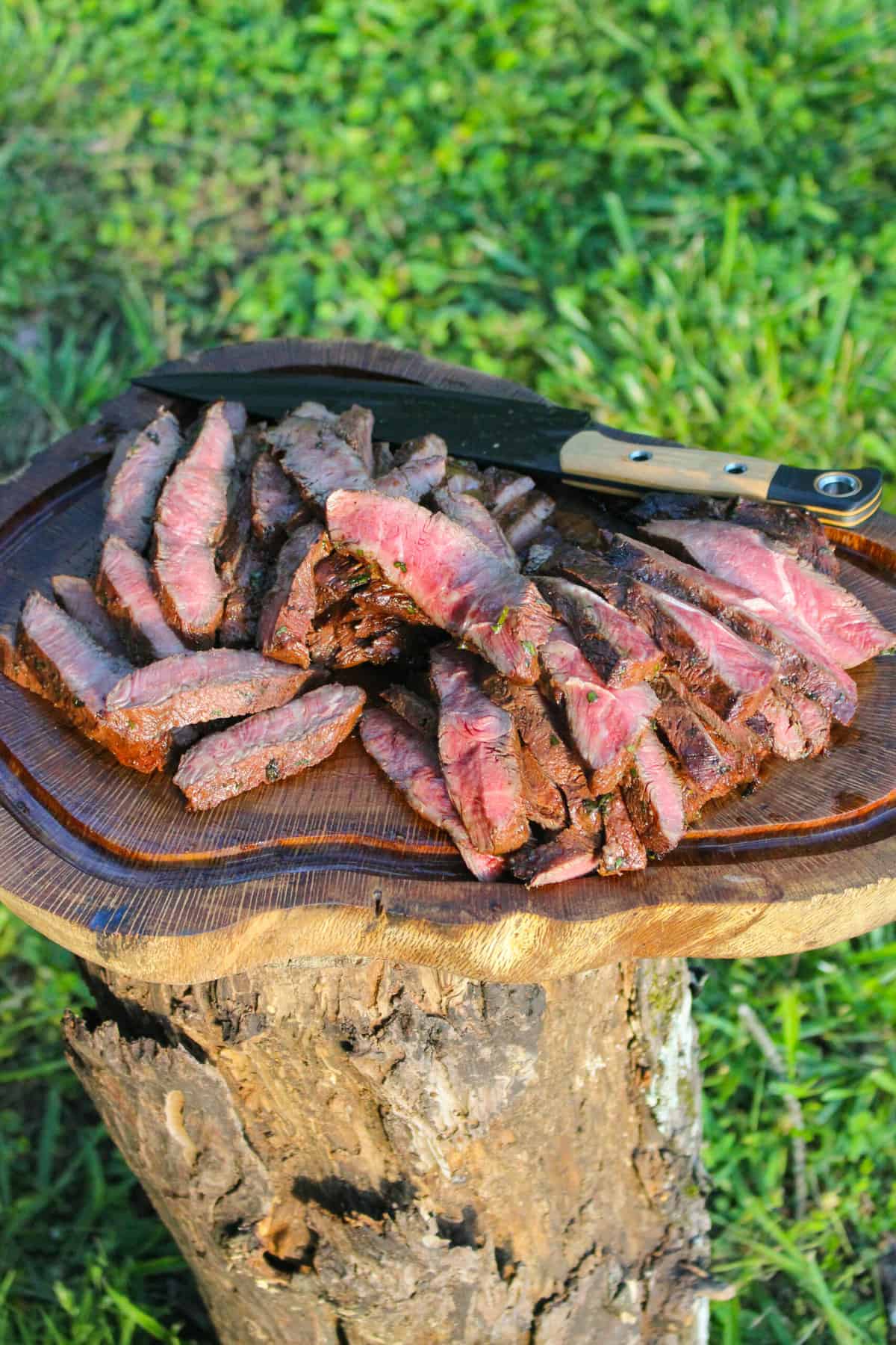 overhead of sliced steak on a cutting board