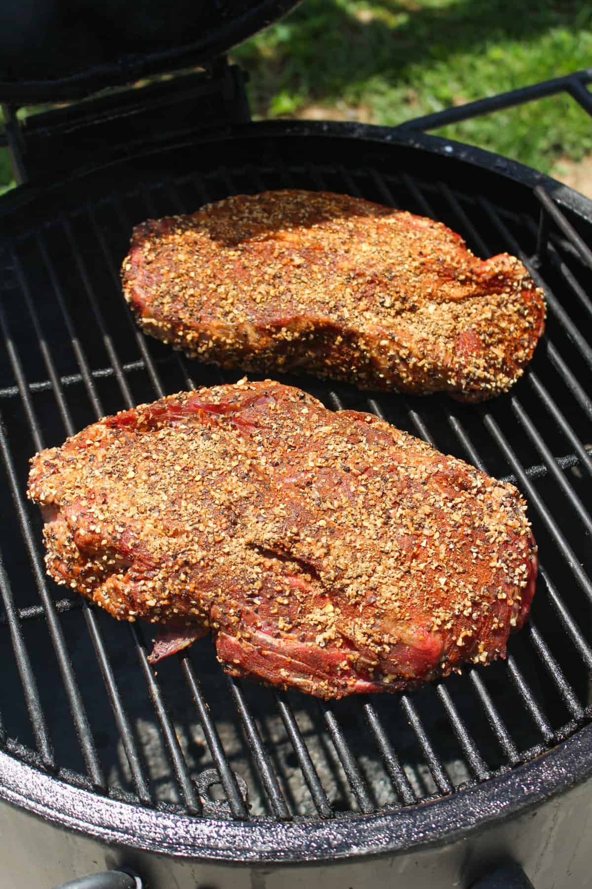 closeup of seasoned chuck roasts on a grill