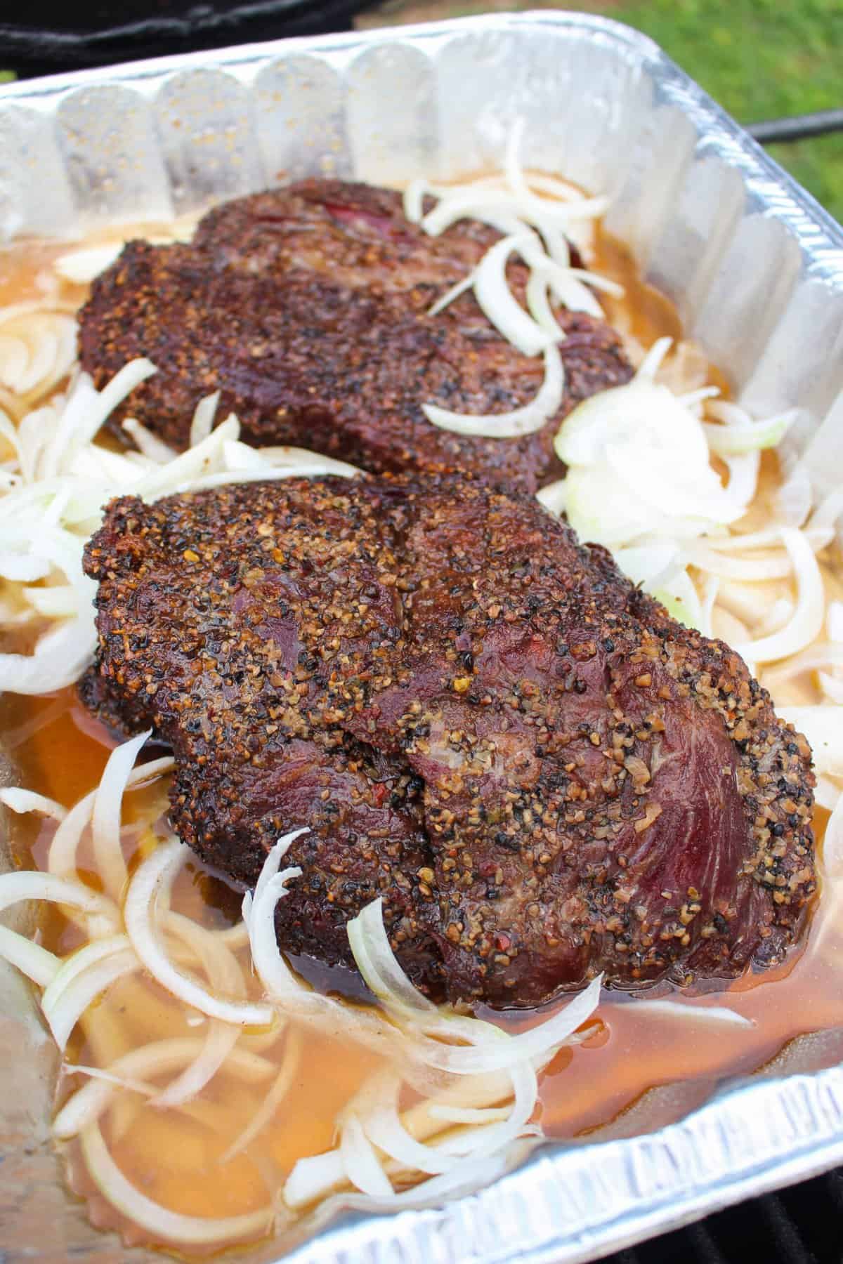 roasts in a foil bin with onion, beef broth, and beer