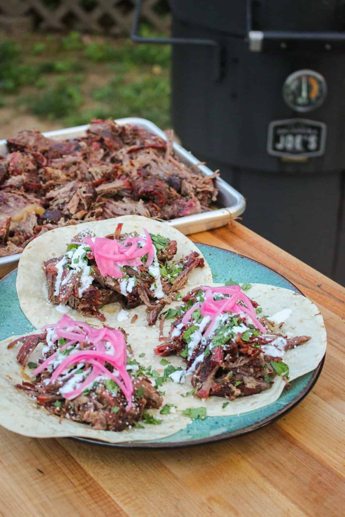 plate of three open faced tacos overhead