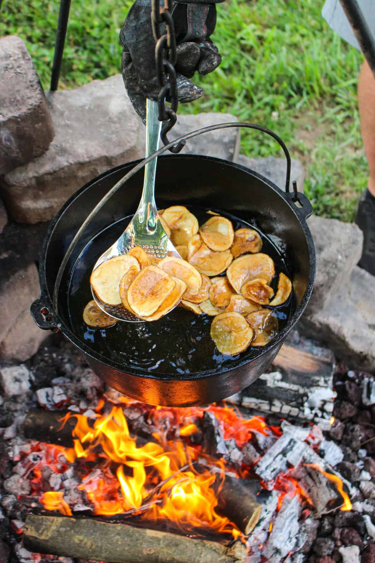 finished kettle chips being pulled out of a pan